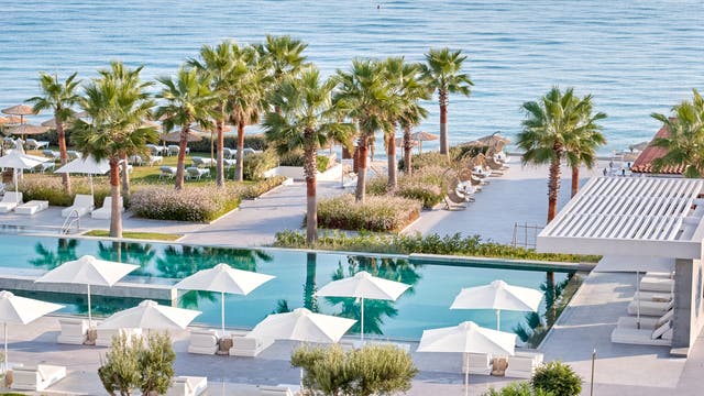 <p>The pool area at Domes Noruz Kassandra overlooks a calm stretch of beach </p>