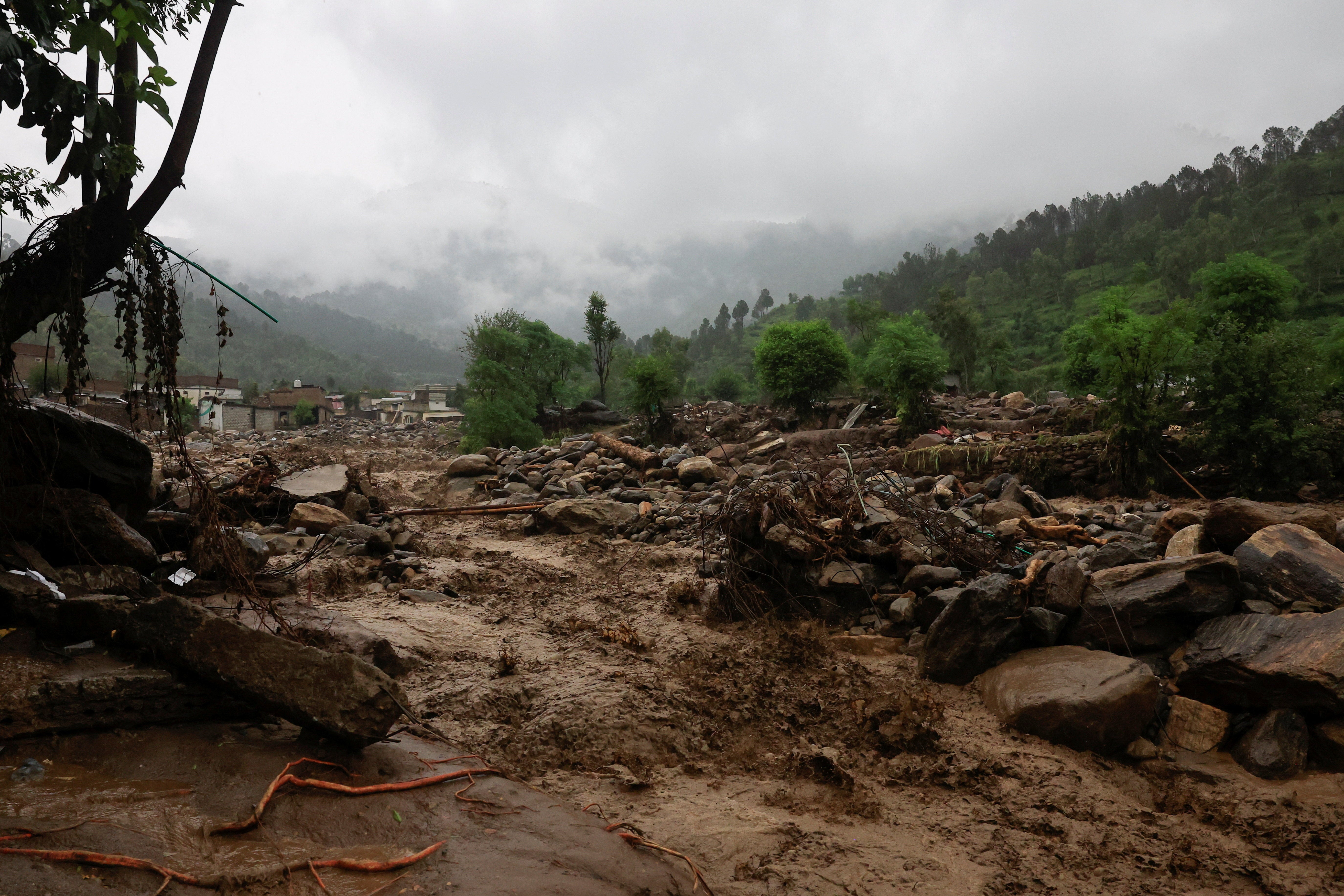 Rain water flowing from mountains crosses a damaged area, following a storm that caused heavy rains and flooding in Bayshonai Kalay
