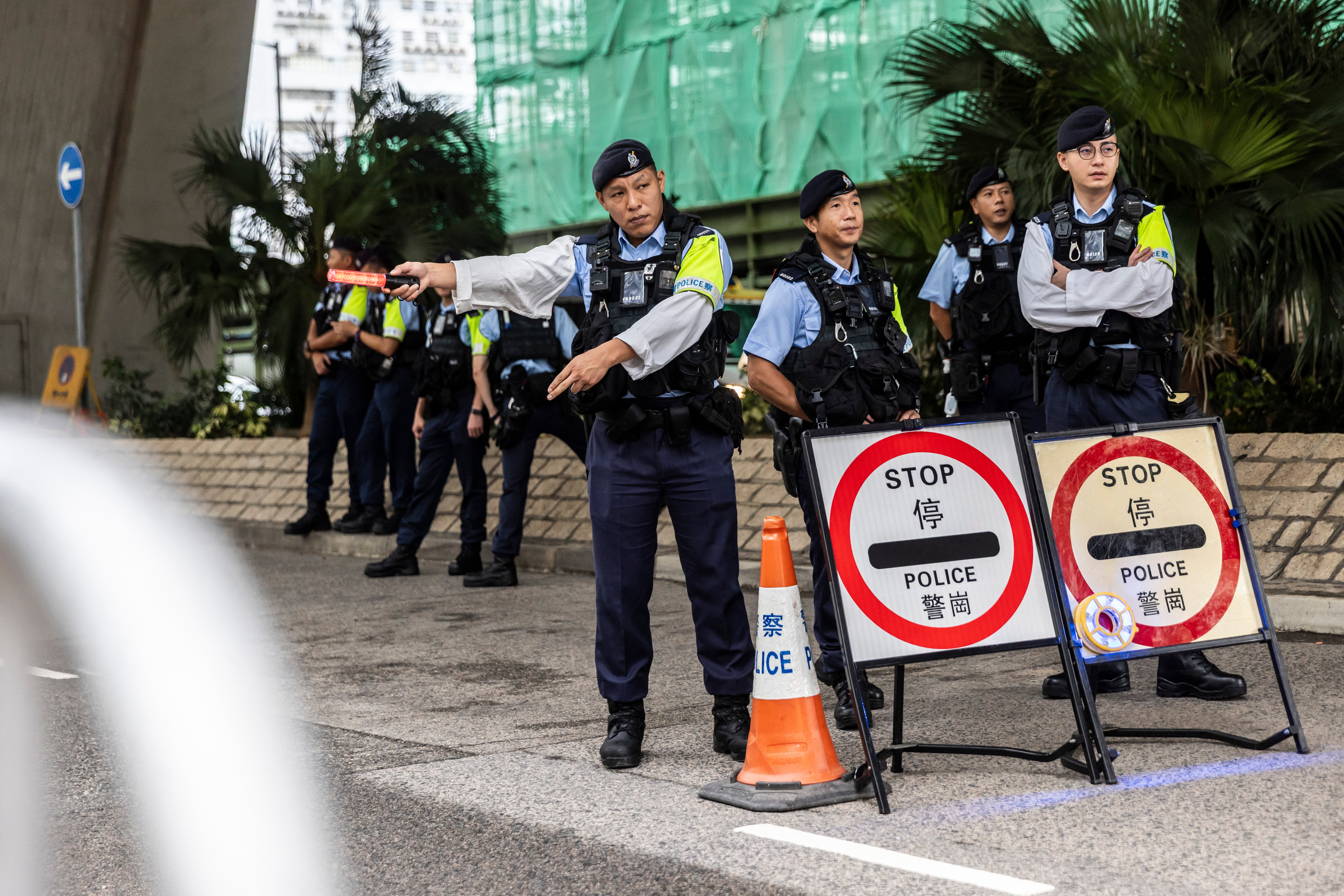 Police set up a roadblock outside the West Kowloon court before Hong Kong media mogul Jimmy Lai arrives for his national security trial on 18 August 2025