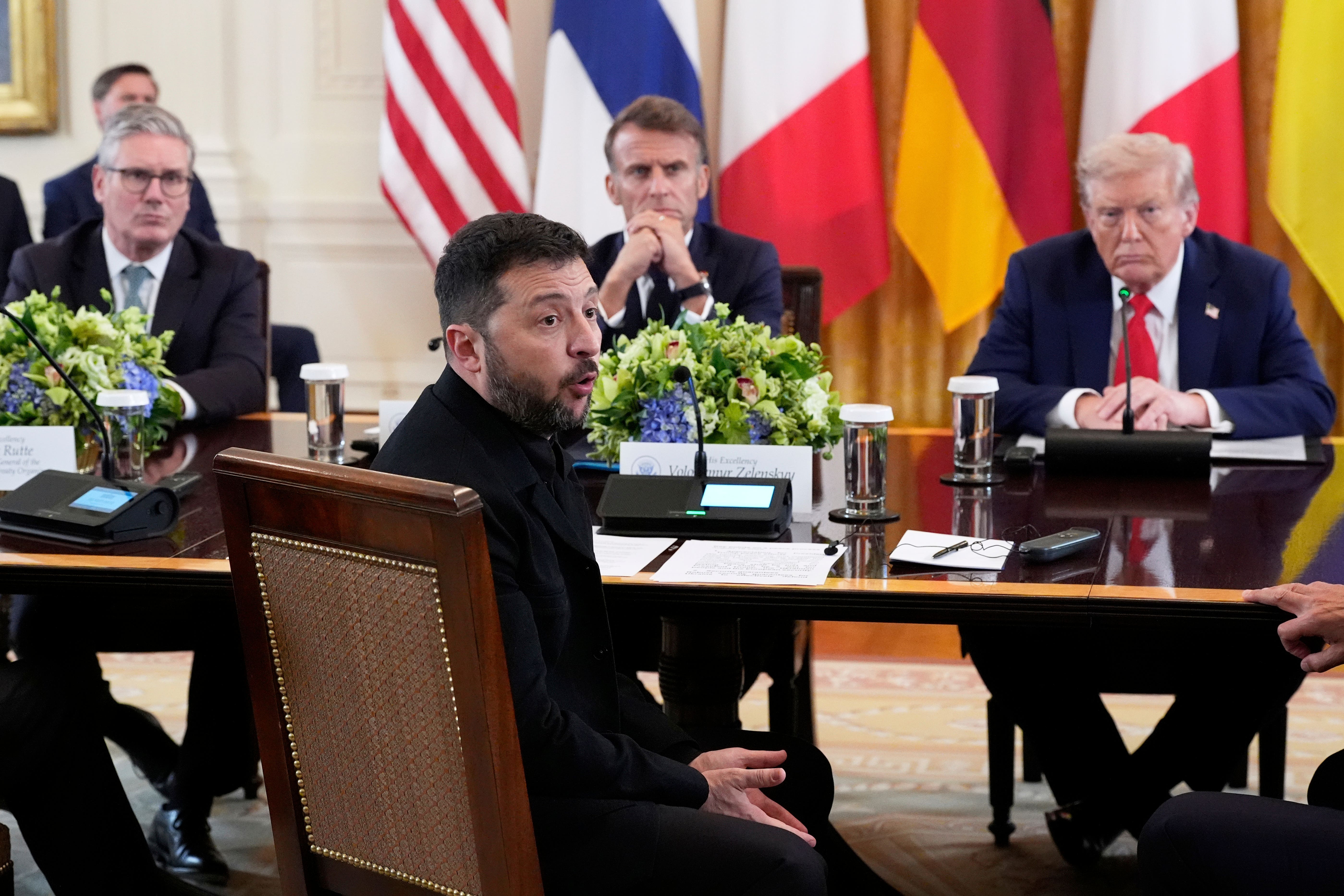 Ukrainian president Volodymyr Zelensky (front) at the negotiating table ahead of closed-door talks, watched on by UK Prime Minister Sir Keir Starmer, French president Emmanuel Macron and US president Donald Trump (Alex Brandon/AP)