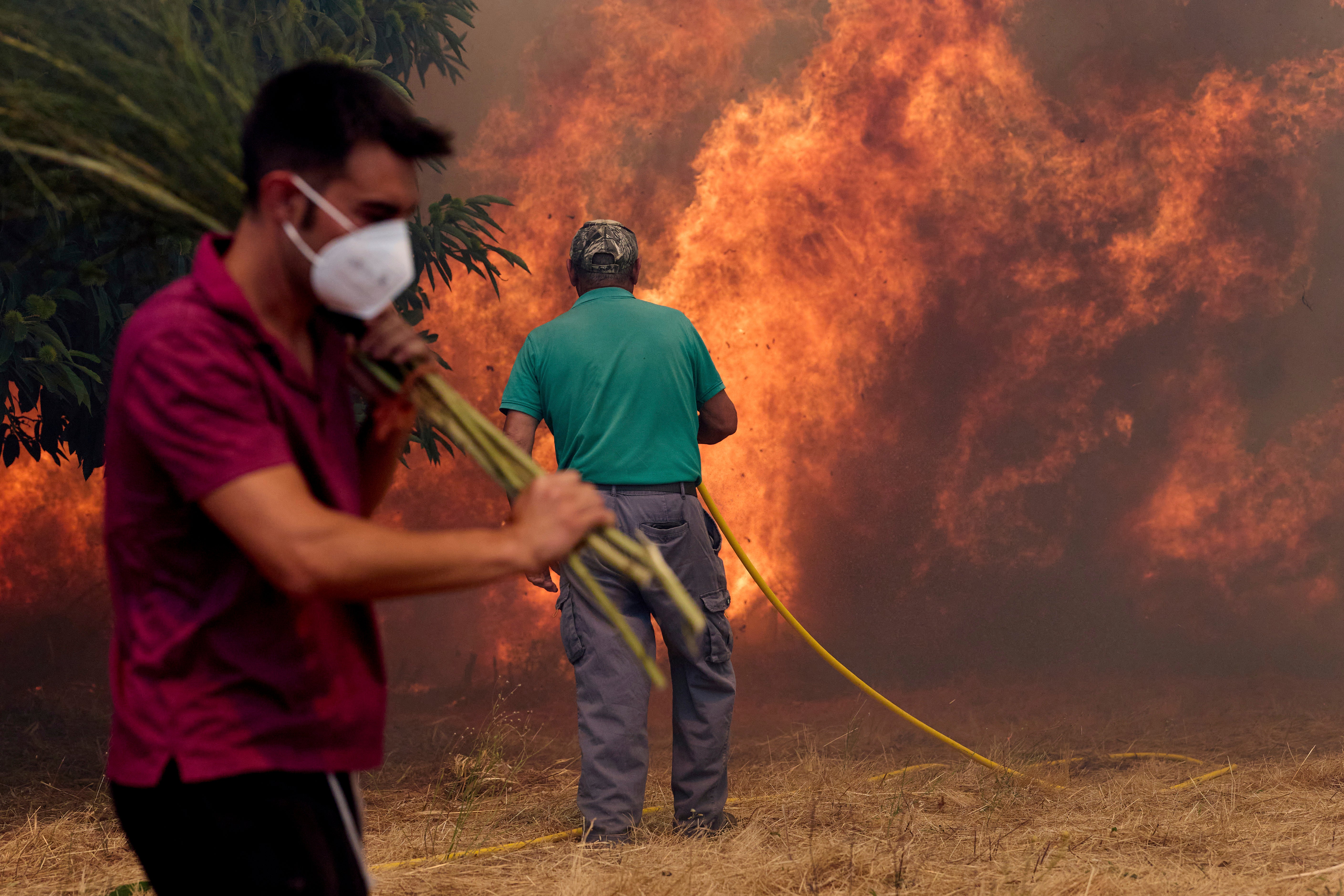 Residents battle a fire advancing toward Rebordondo village