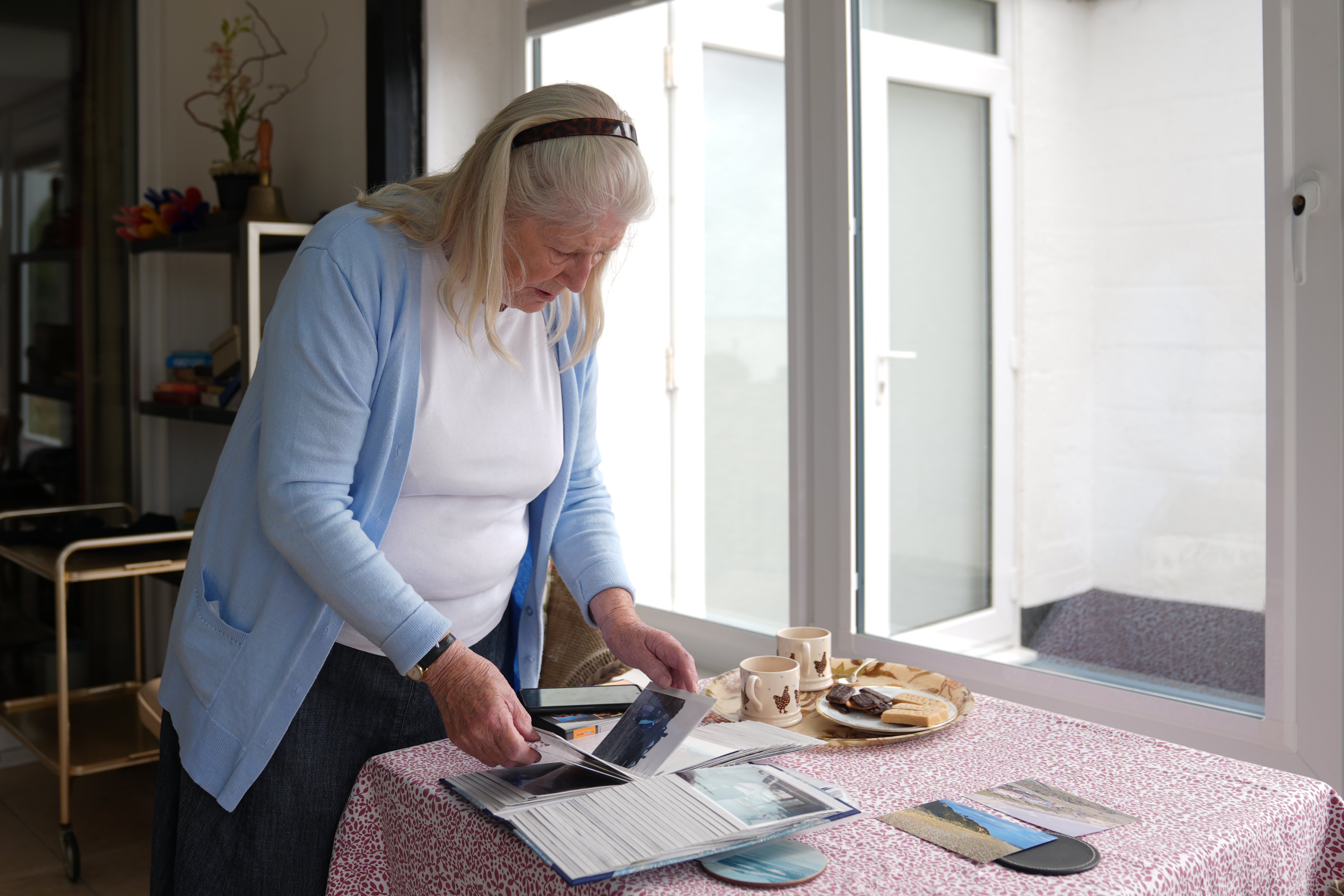 Jean Flick looking through family photos at her home