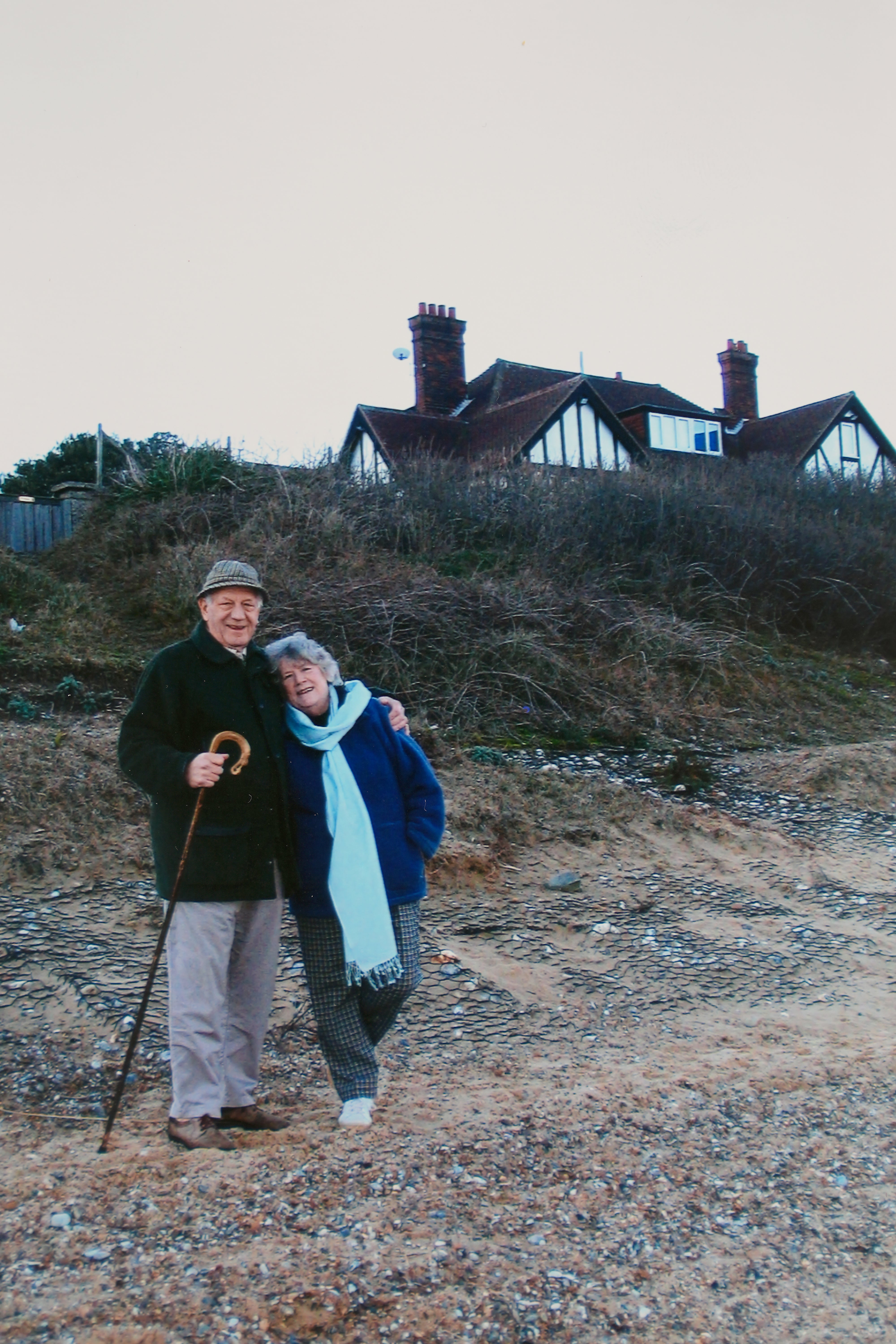 Jean Flick pictured with her late husband on the beach below their home in Thorpeness, Suffolk