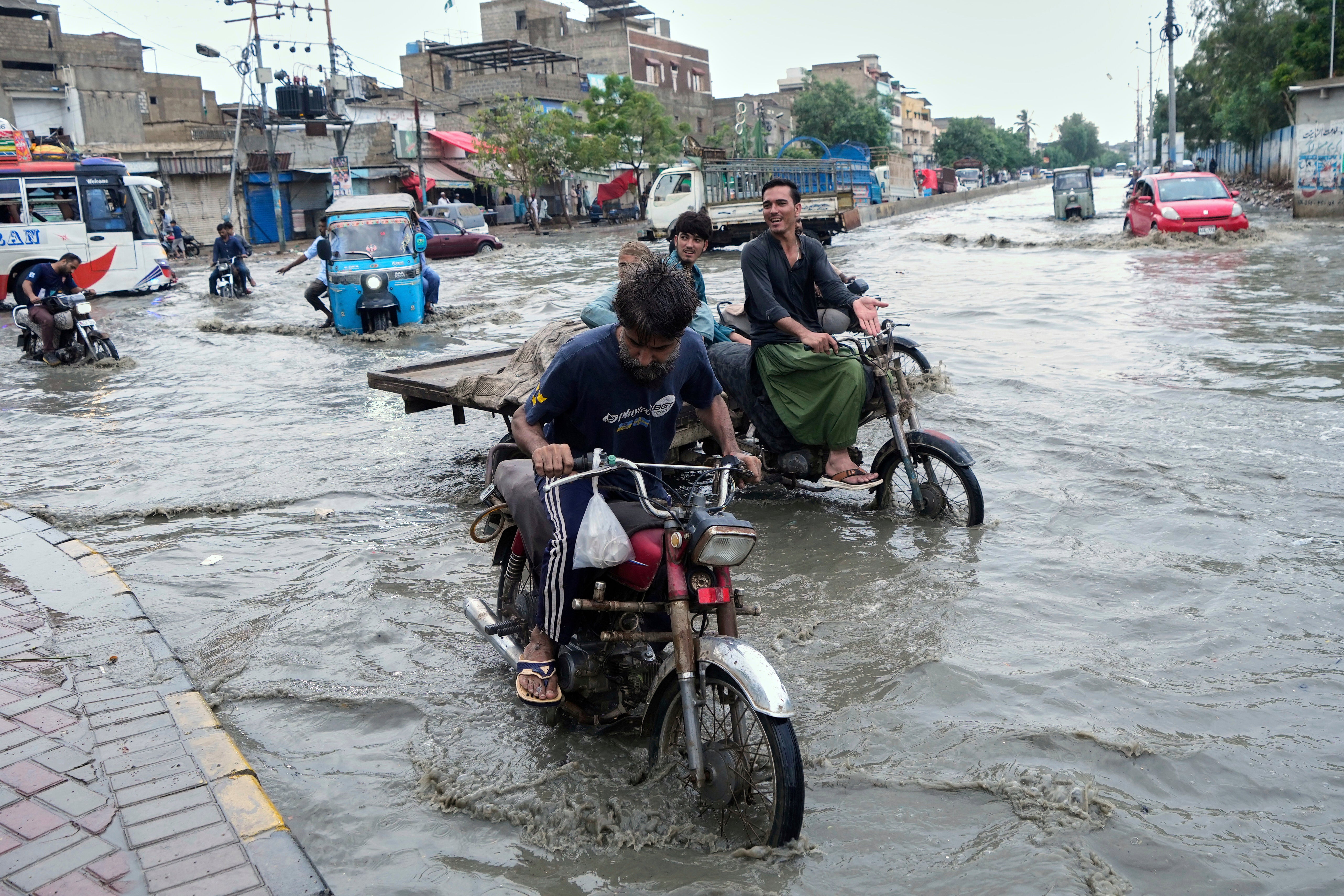 Motorists make their way through heavily flooded roads in the region