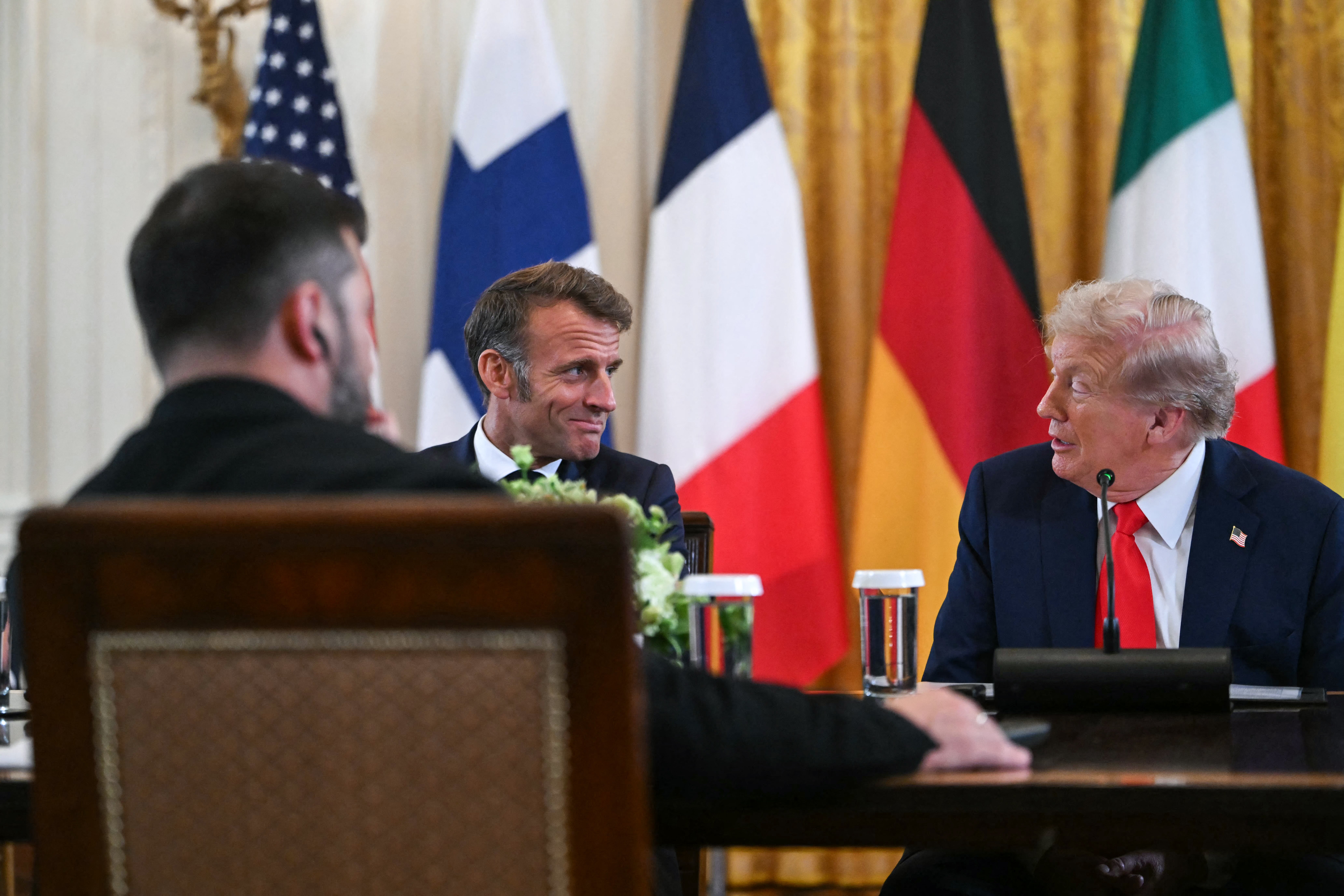Ukrainian president Volodymyr Zelensky, French president Emmanuel Macron, and US president Donald Trump attend a meeting with European leaders in the East Room of the White House in Washington DC on 18 August