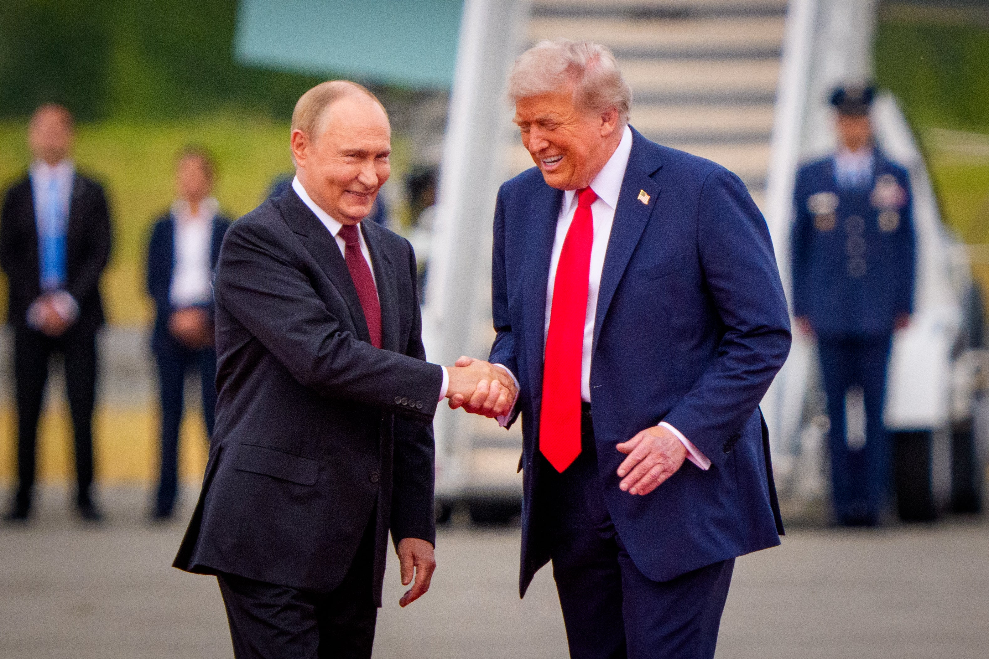 Donald Trump greets Vladimir Putin as he arrives at Joint Base Elmendorf-Richardson in Anchorage, Alaska last Friday