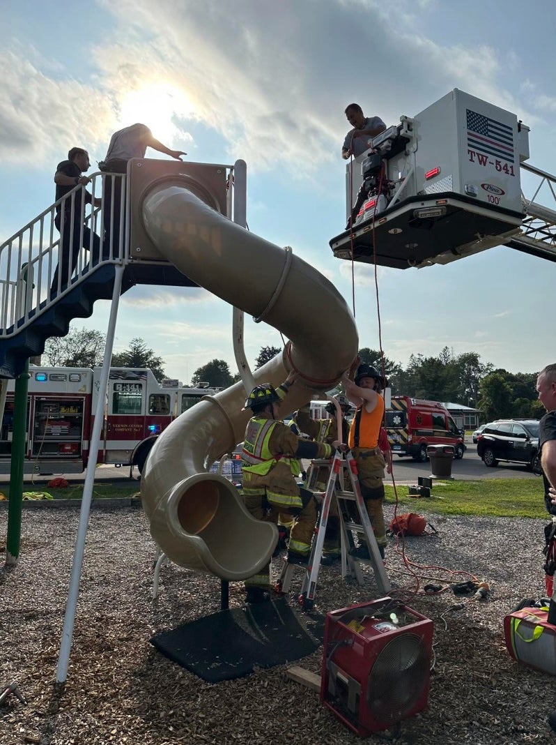 A crew of Connecticut firefighters was forced to cut open a children’s playground slide to release a middle-aged man stuck inside