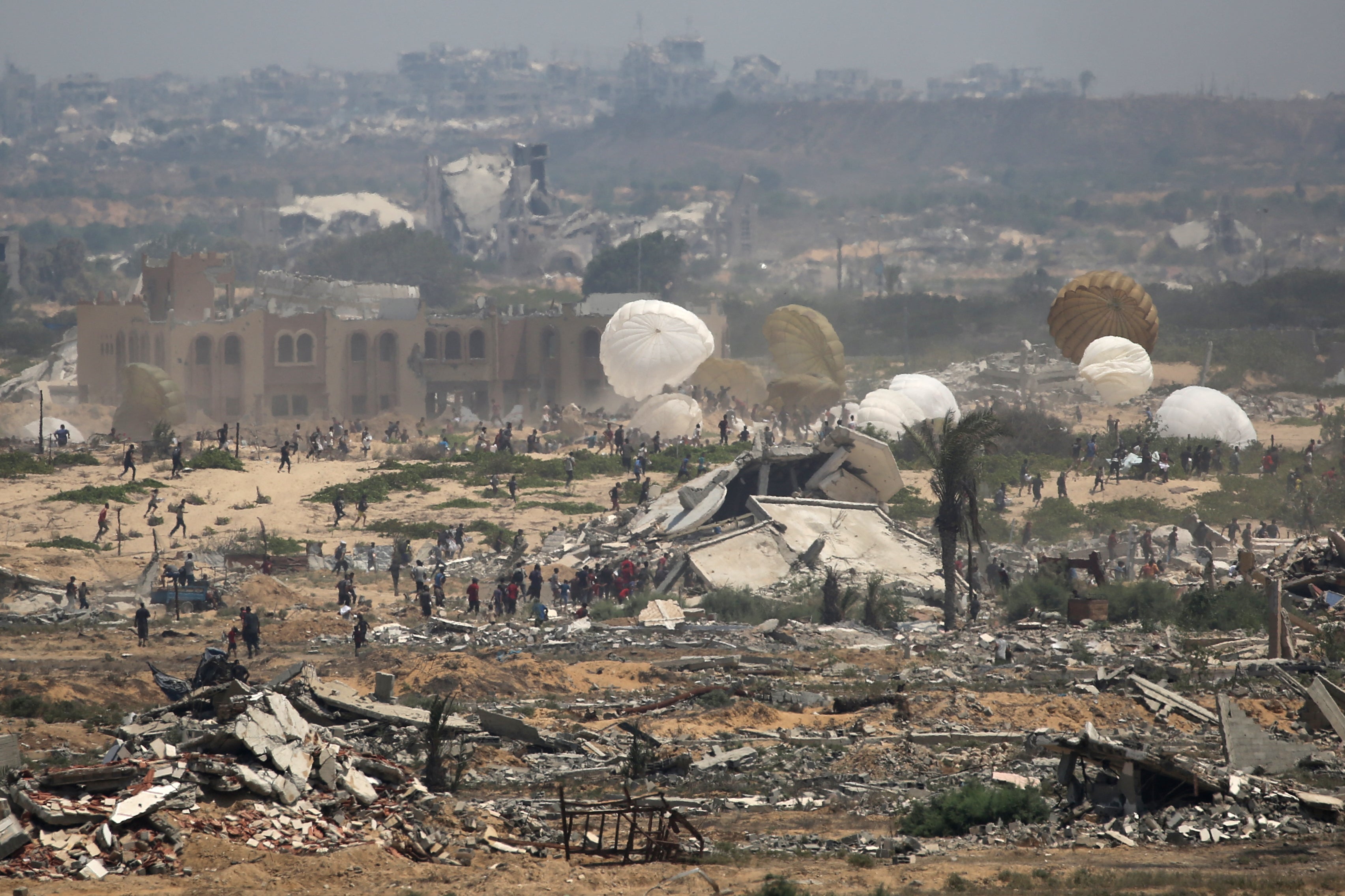 Aid pallets are parachuted after being dropped from a military plane over Nuseirat in the central Gaza Strip during an airdrop mission above the Israel-besieged Palestinian territory on 18 August 2025