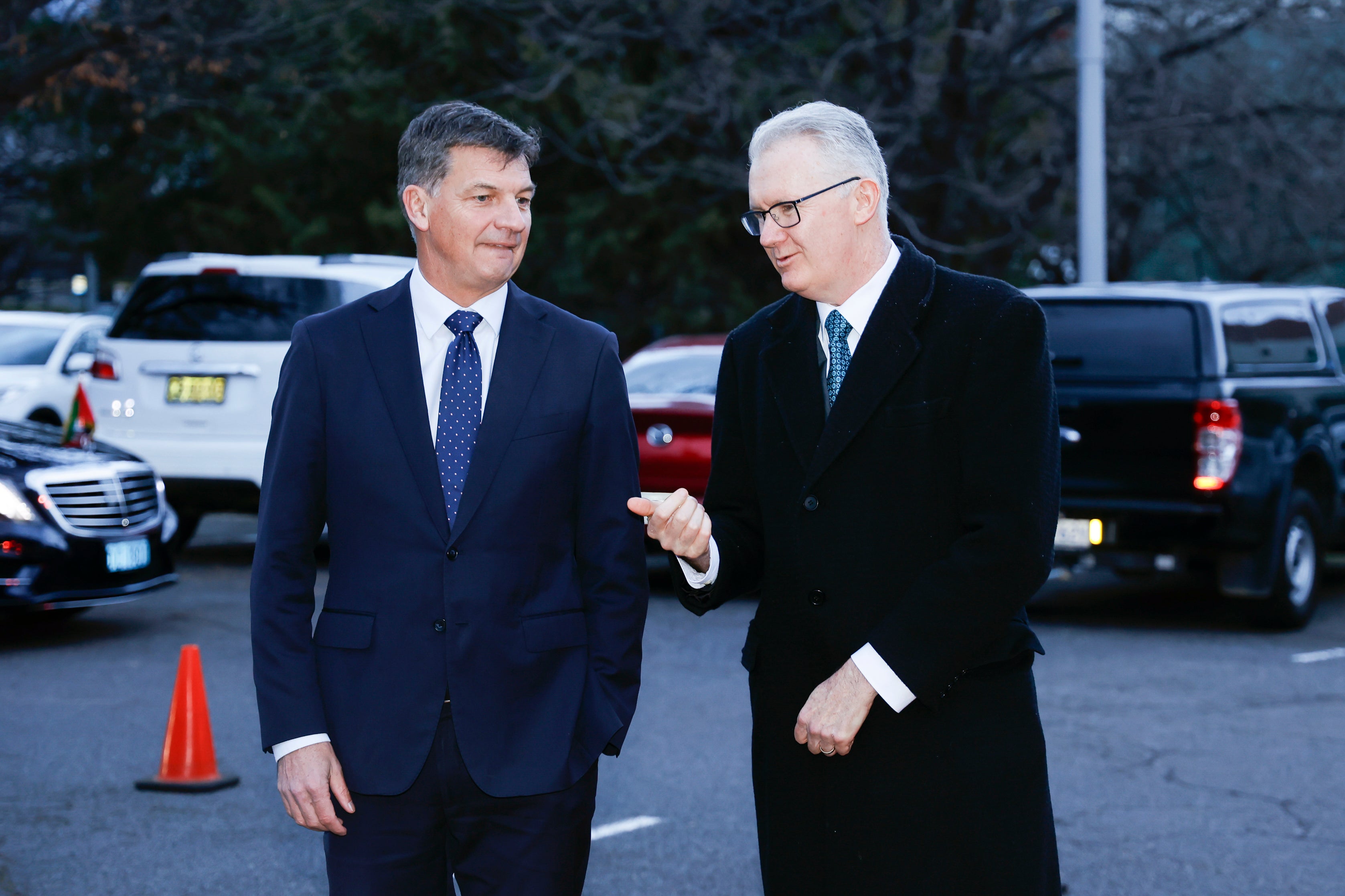Shadow minister for defence Angus Taylor MP (L) and minister for home affairs Tony Burke MP speak before the ecumenical service at Wesley Church on 22 July 2025 in Canberra