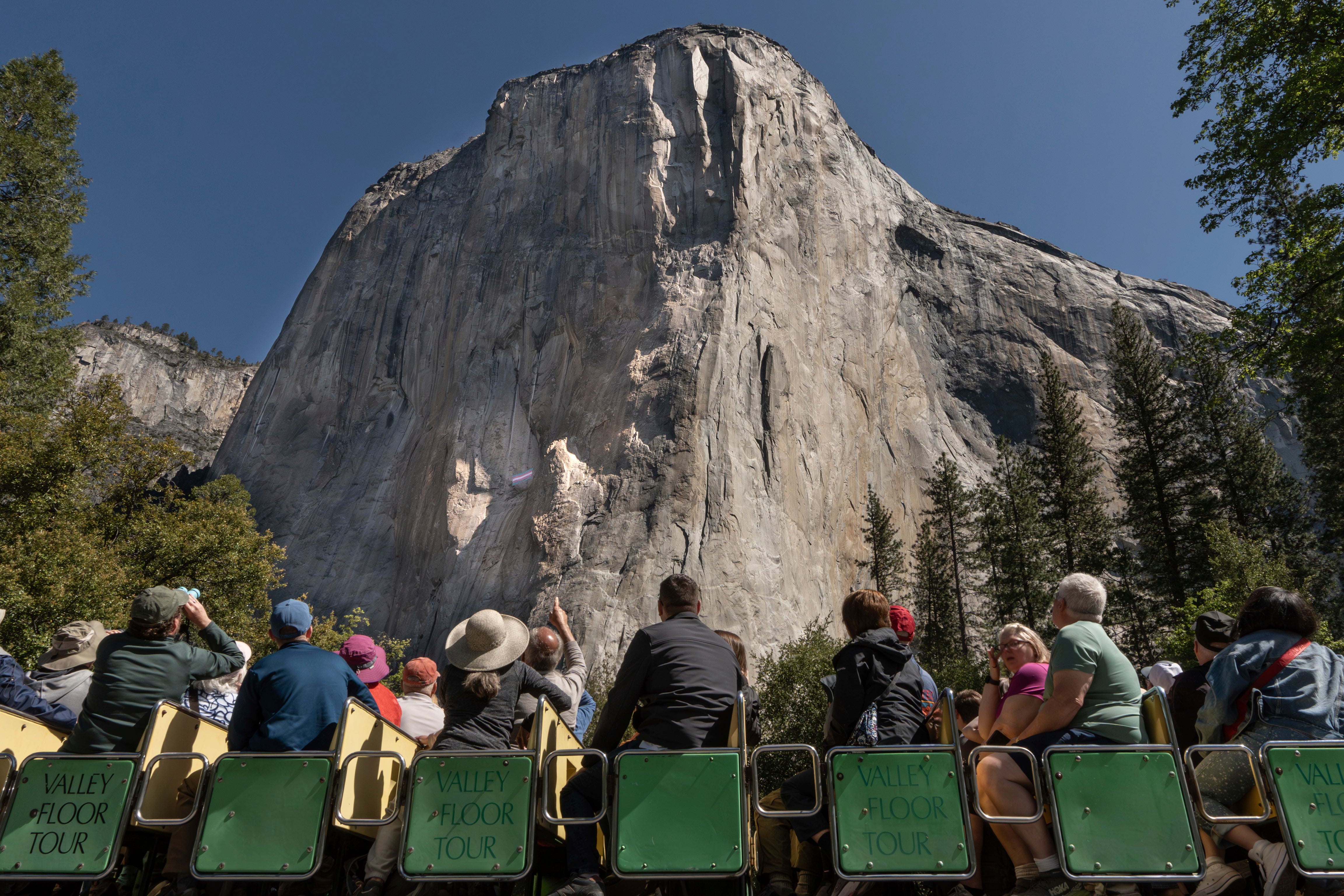 Yosemite visitors view El Capitan, where a transgender flag hangs in Yosemite National Park, Calif., May 20, 2025