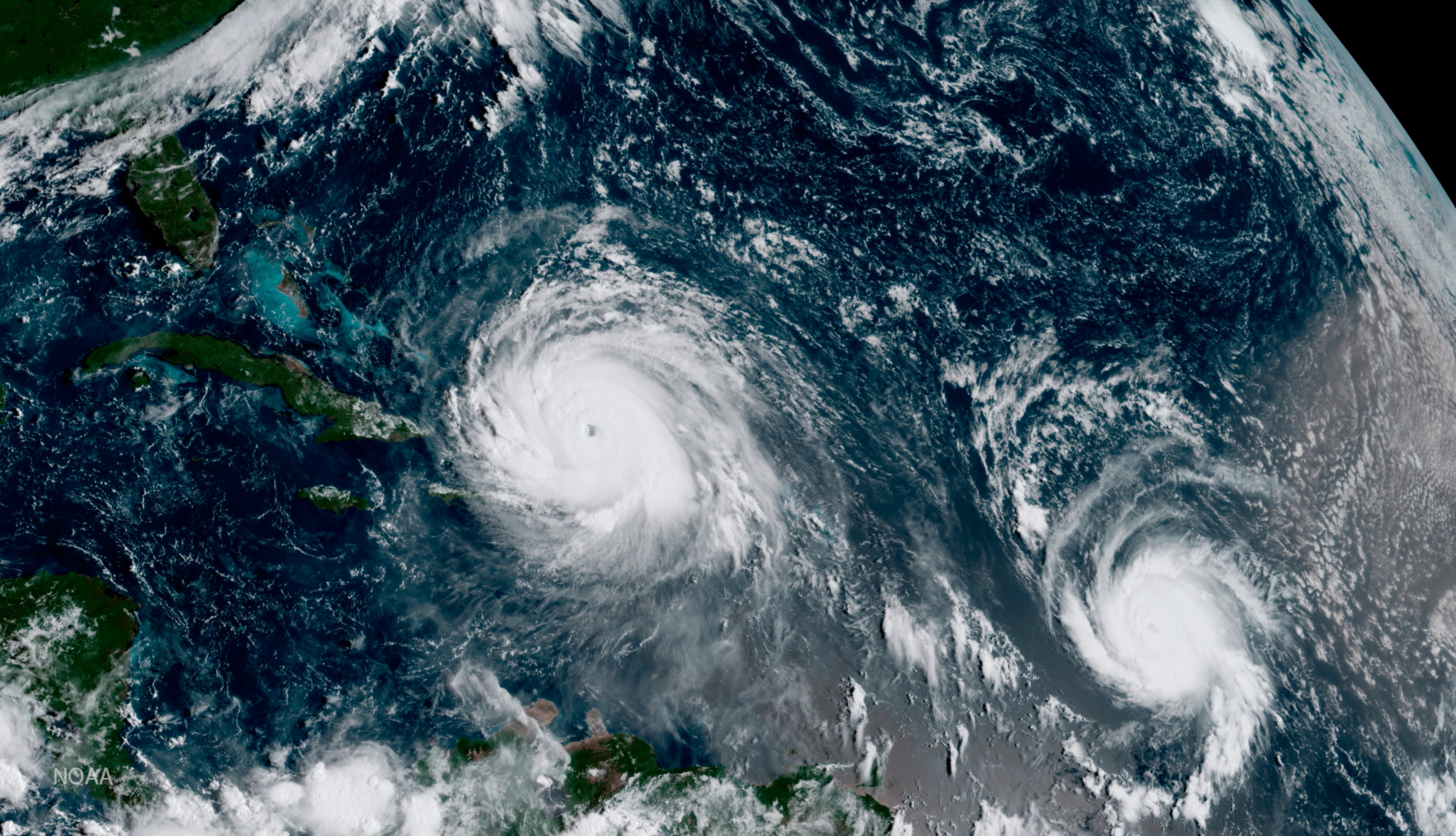 <p>The eye of Hurricane Irma, left, just north of the island of Hispaniola, with Hurricane Jose, right, in the Atlantic Ocean</p>