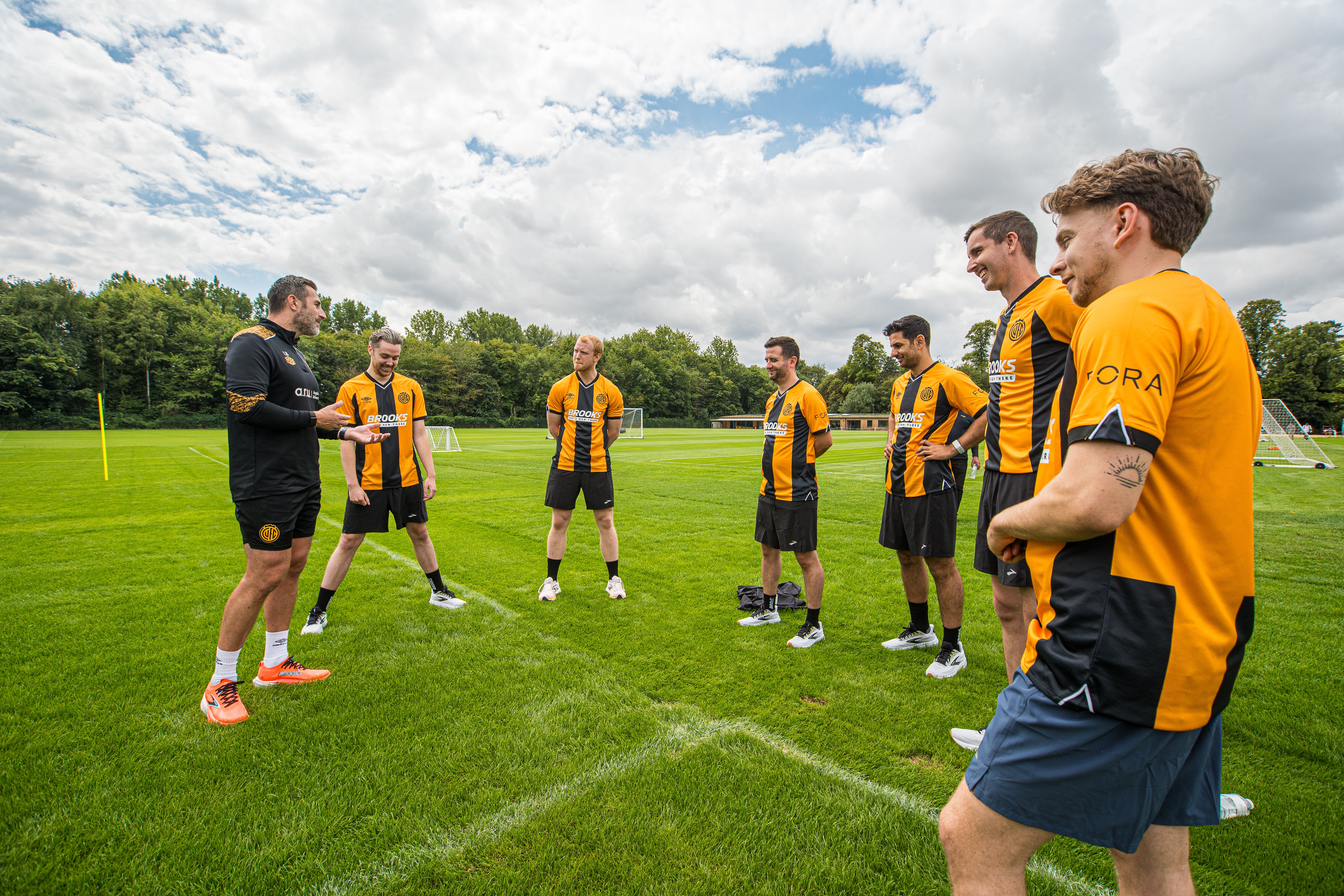 Cambridge United's executive performance lead Laurence Bloom taking journalists through a warm-up