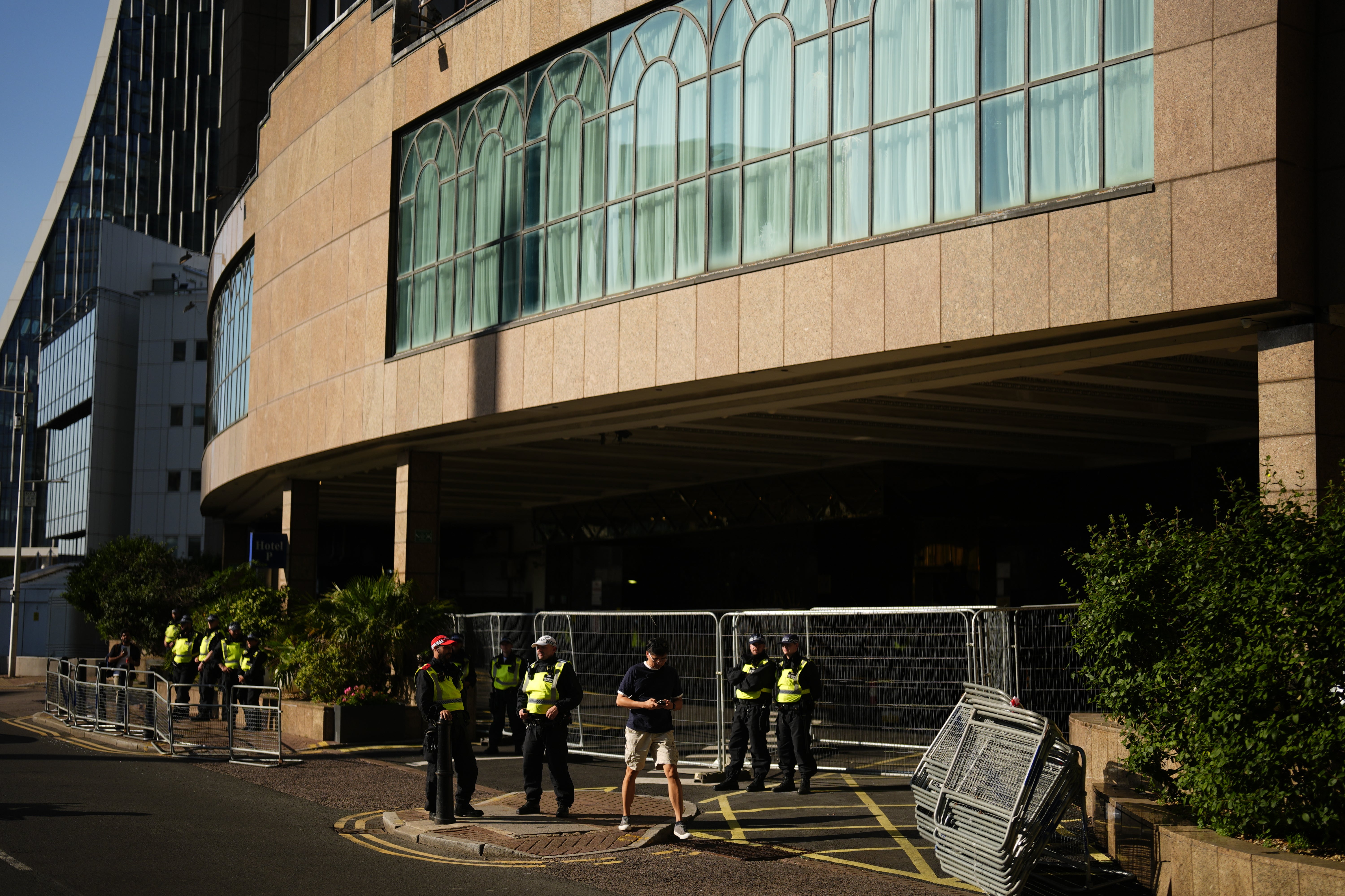 Police officers stand by barricades at a hotel housing asylum seekers (Jordan Pettitt/PA)