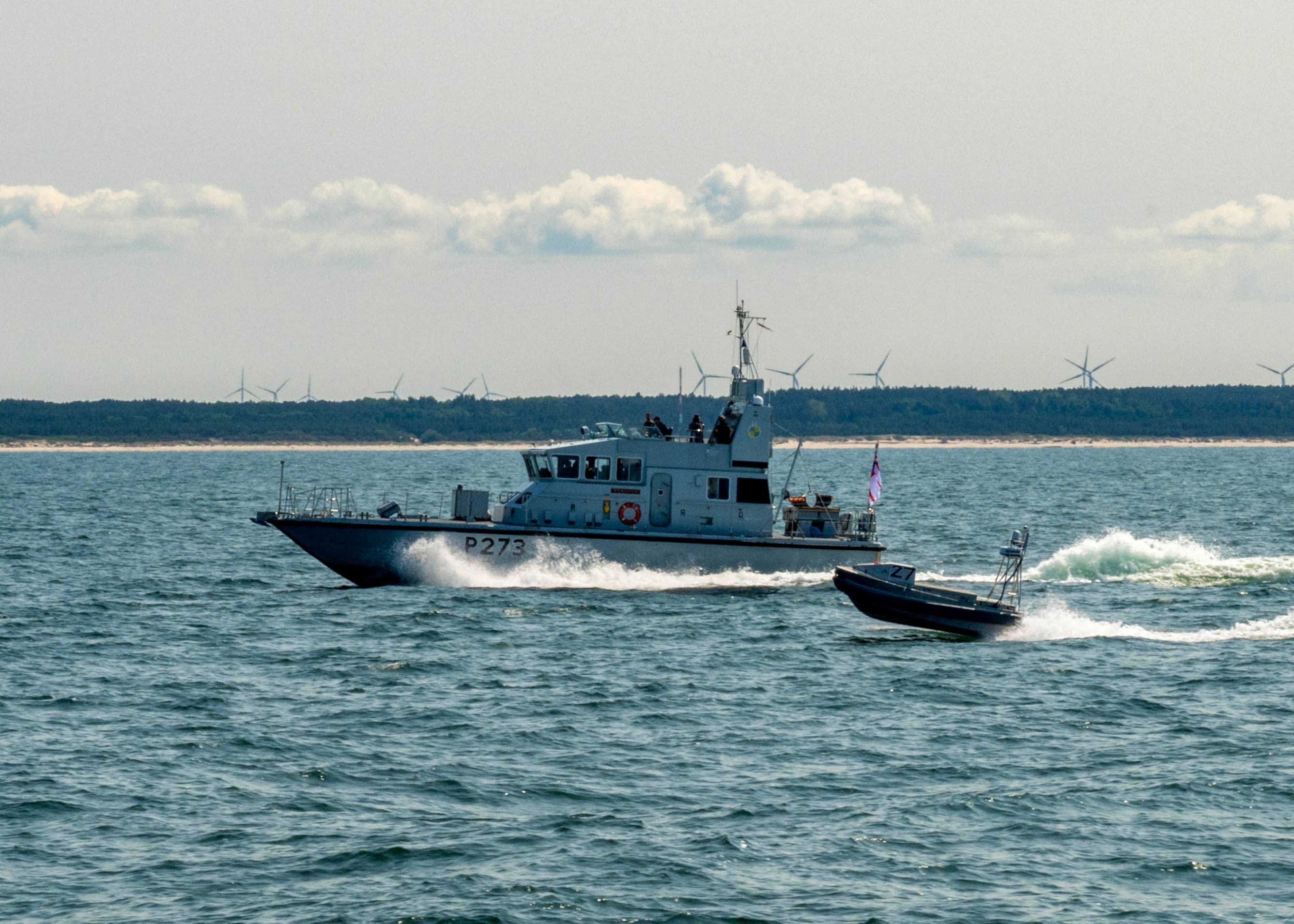 A Royal Navy vessel can be seen alongside an autonomous boat in the Baltic Sea on June 12. The recently passed ‘Big, Beautiful, Bill’ included almost $5 billion for maritime autonomous systems.