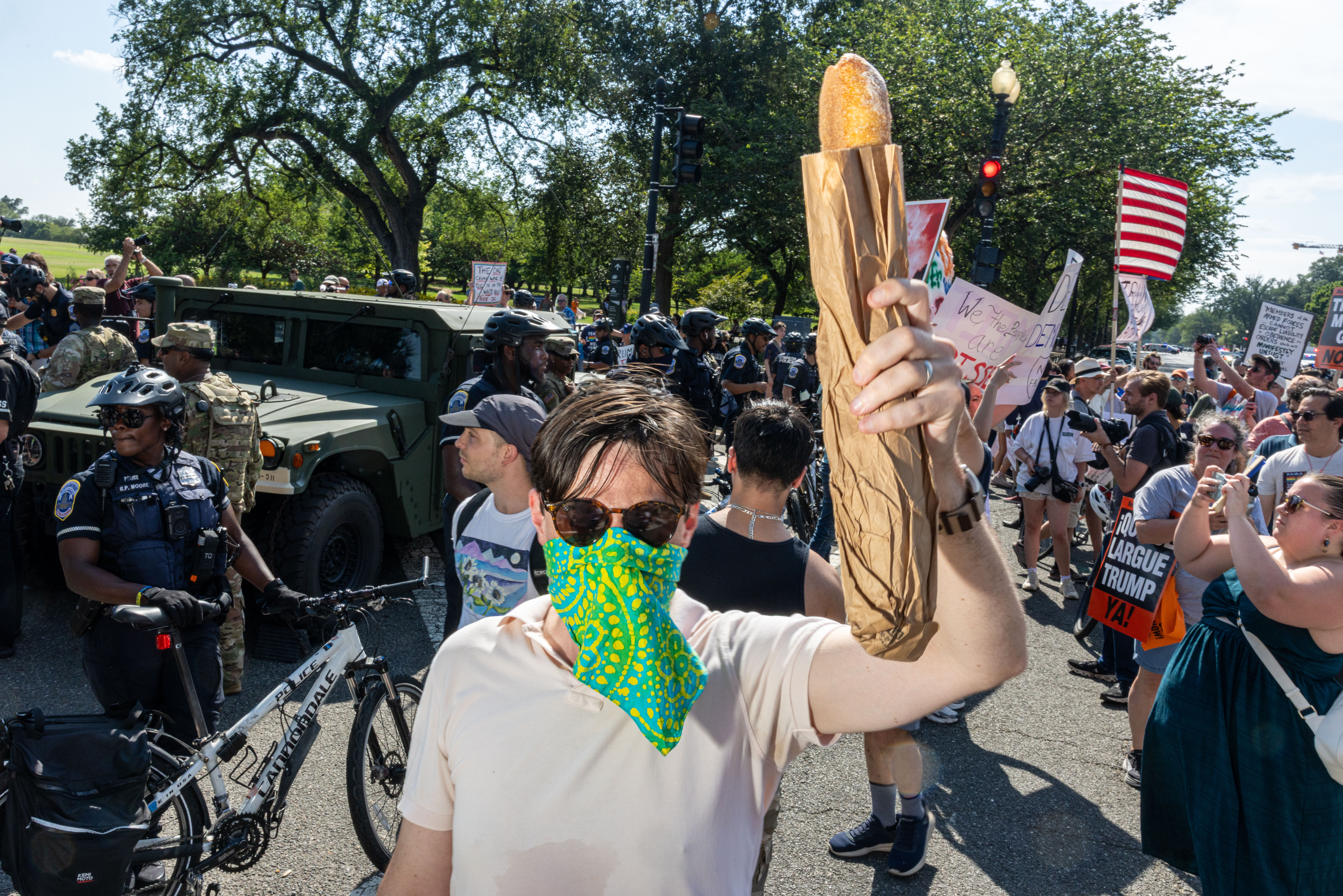 A demonstrator holds a piece of bread as he protests against the increased federal law enforcement presence in Washington, D.C., on Saturday