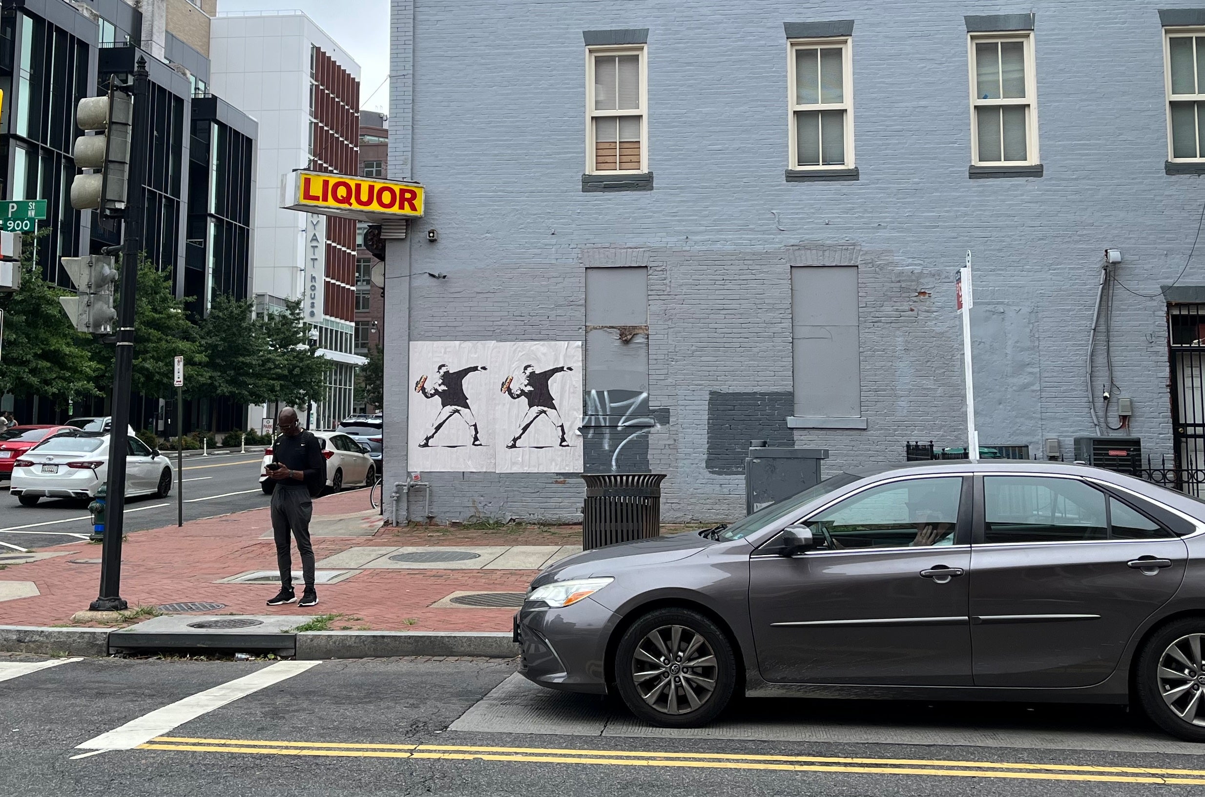 Two Banksy-style portraits honoring the D.C. sandwich thrower are seen at a bus stop near the Logan Circle neighborhood