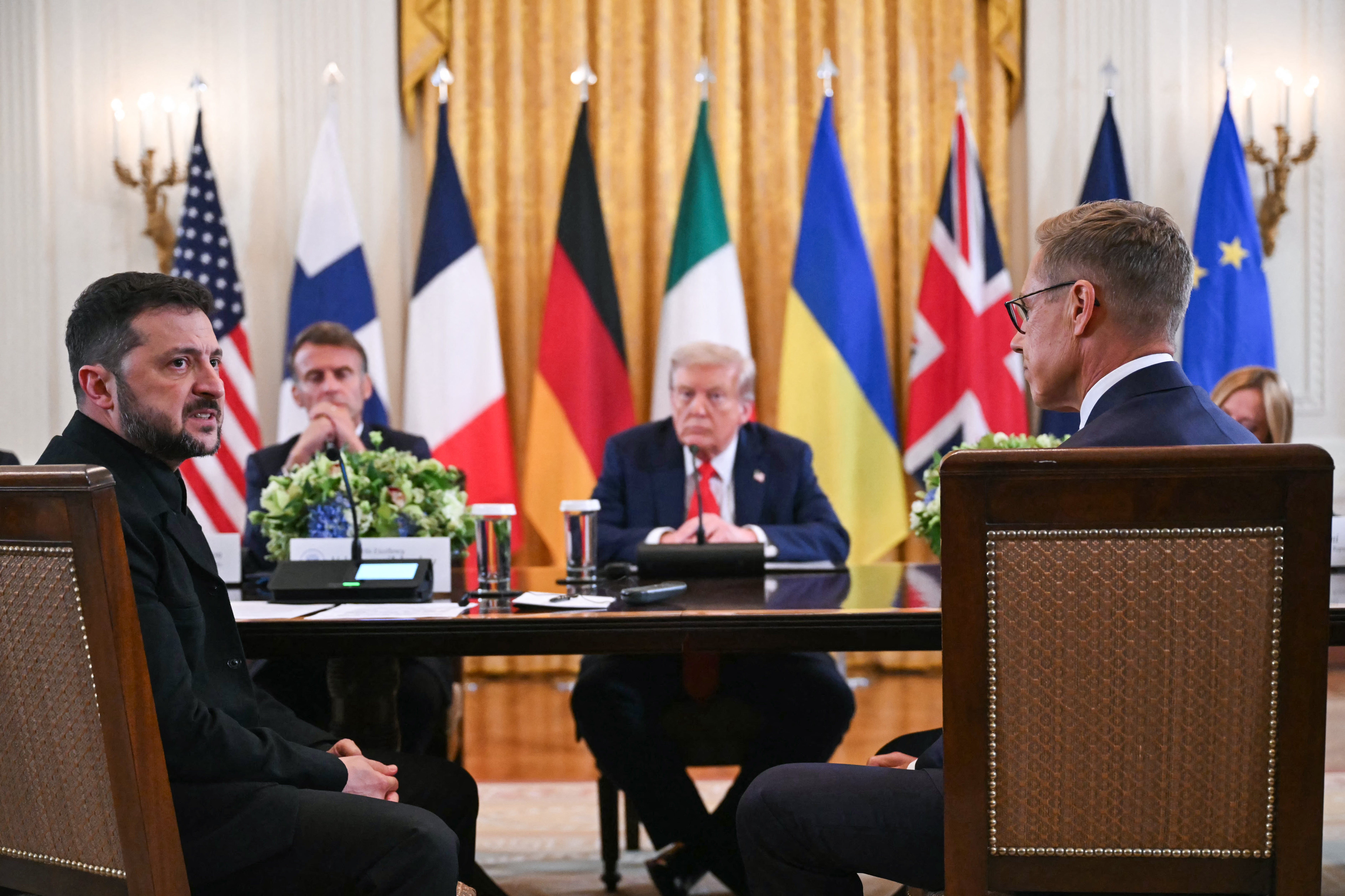 Ukrainian President Volodymyr Zelensky speaks as French President Emmanuel Macron, US President Donald Trump and Finnish President Alexander Stubb listen during a meeting with European leaders in the East Room of the White House in Washington, DC
