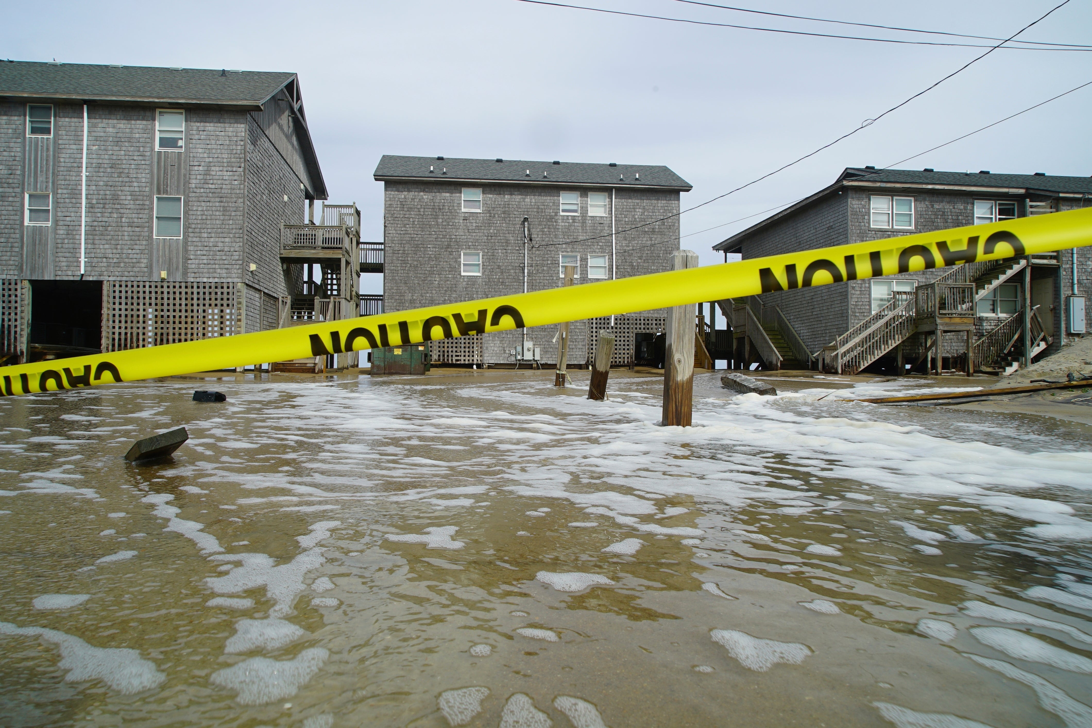 Sea water pushed inland by Hurricane Erin surges under the Cape Hatteras Motel in Buxton, North Carolina. NASA wants Americans to help document damage from tropical storms