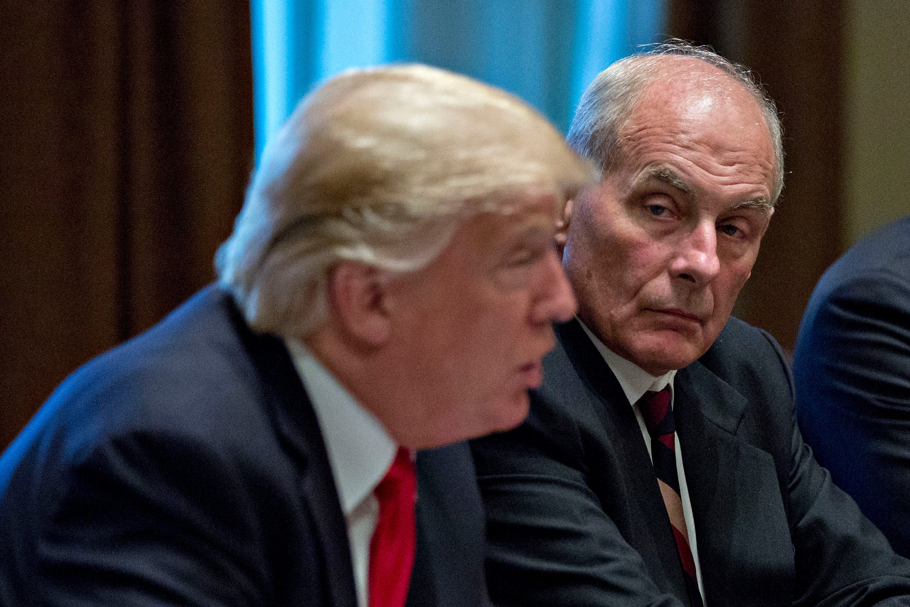 White House chief of staff John Kelly listens as President Donald Trump speaks in October 2017