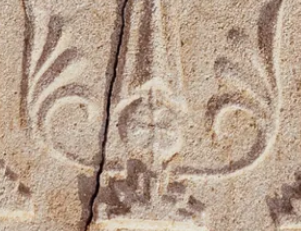 The cross shows a stepped pyramid representing Golgotha, where Christians believe Jesus was crucified, and leaves sprouting from its base