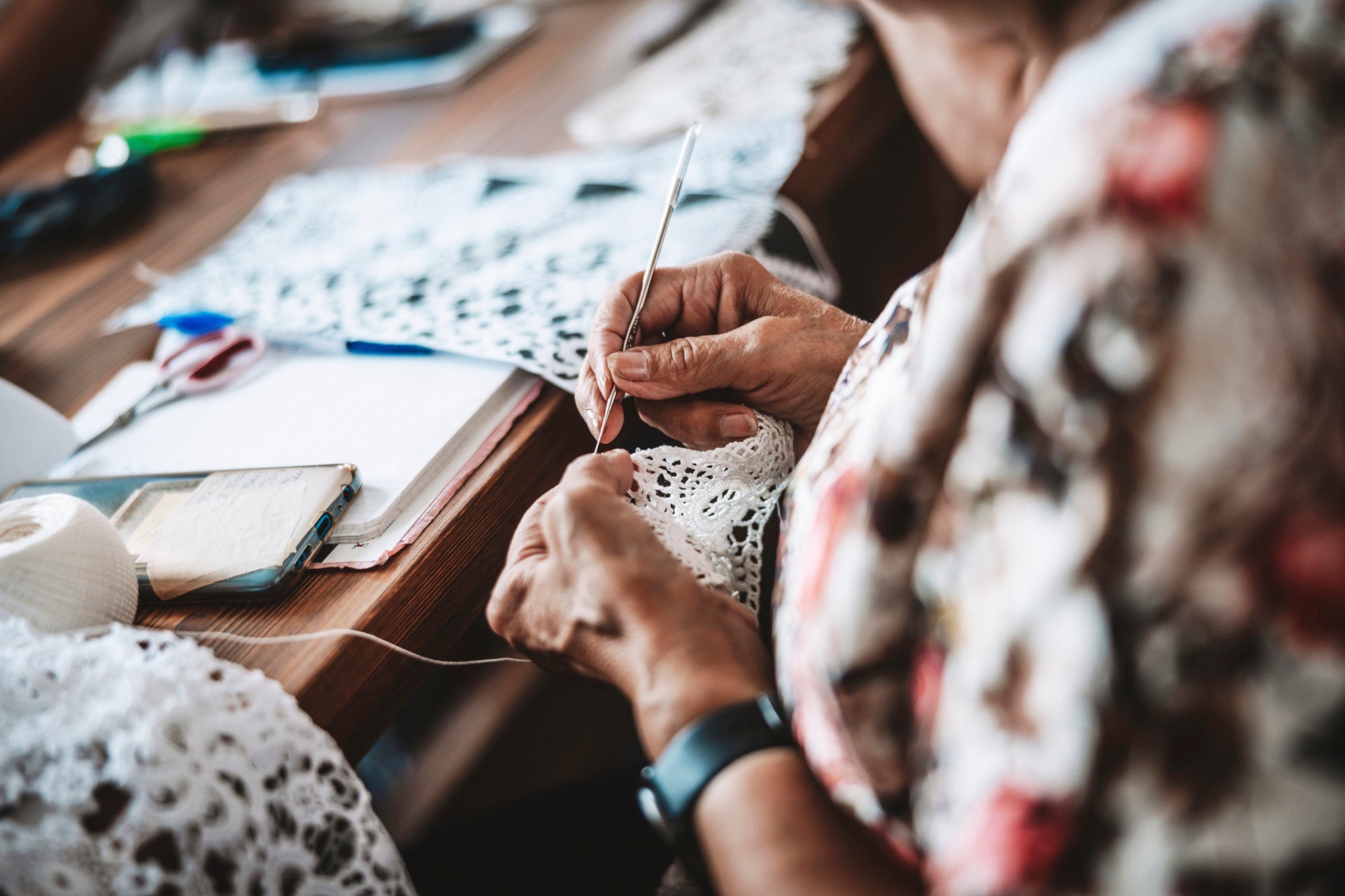A woman makes traditional lace from cotton yarn in the village of Koniakow, in Poland's Beskid Mountains, Sunday, Aug. 17, 2025. (AP Photo/Daniel Franek)