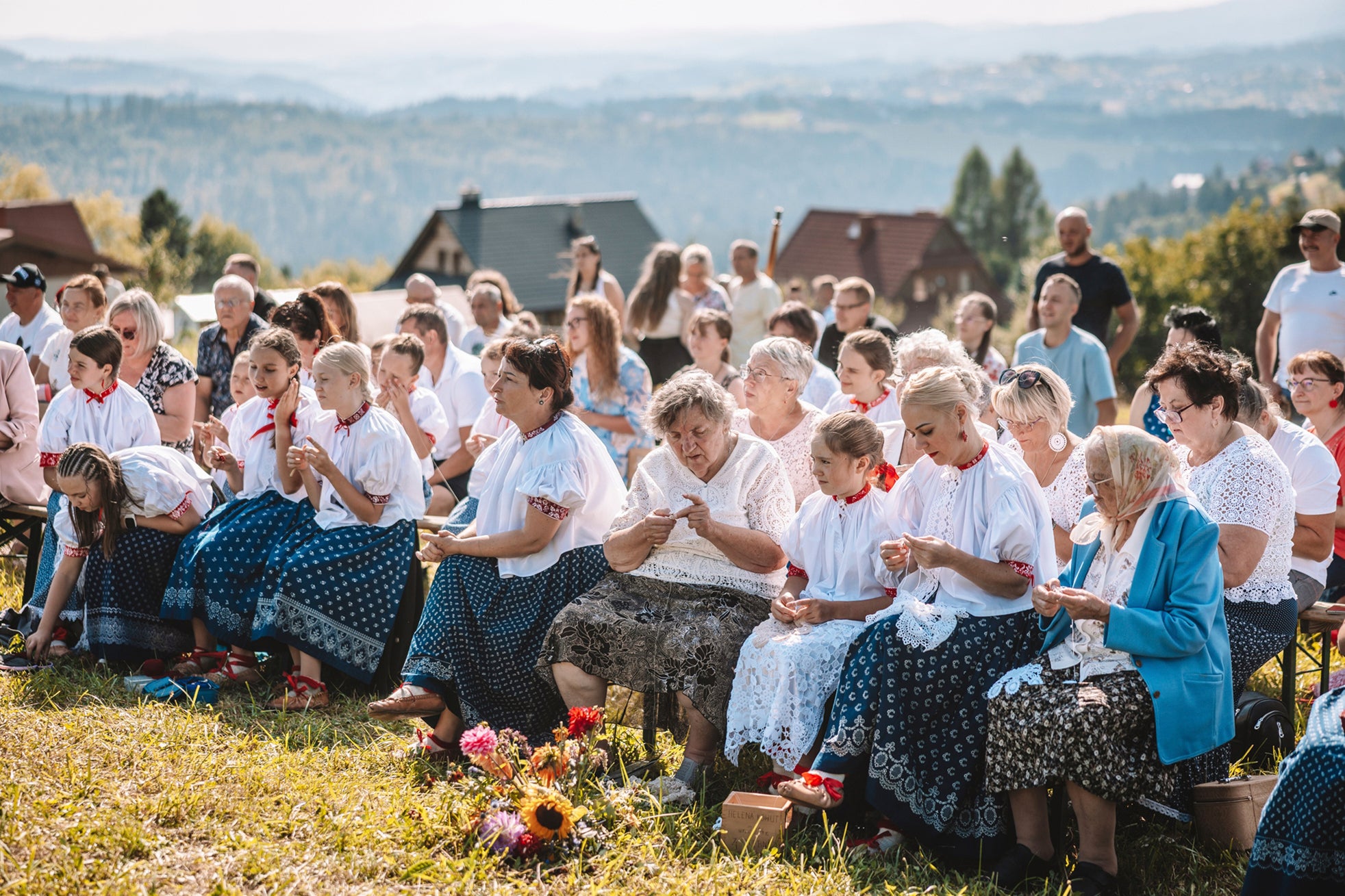 Women practice "hekla", the traditional art of hand-crocheted lace making, on a valley slope in the village of Koniakow, Poland, Sunday, Aug. 17, 2025. (AP Photo/Daniel Franek)