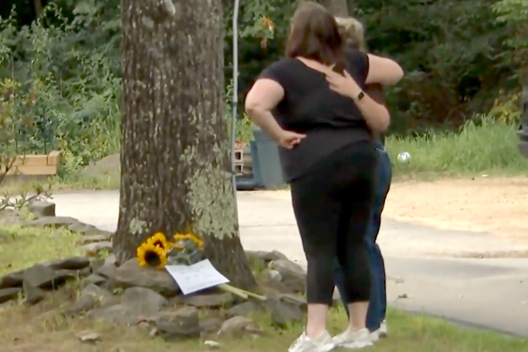 People leaving tributes to the family outside their New Hampshire house
