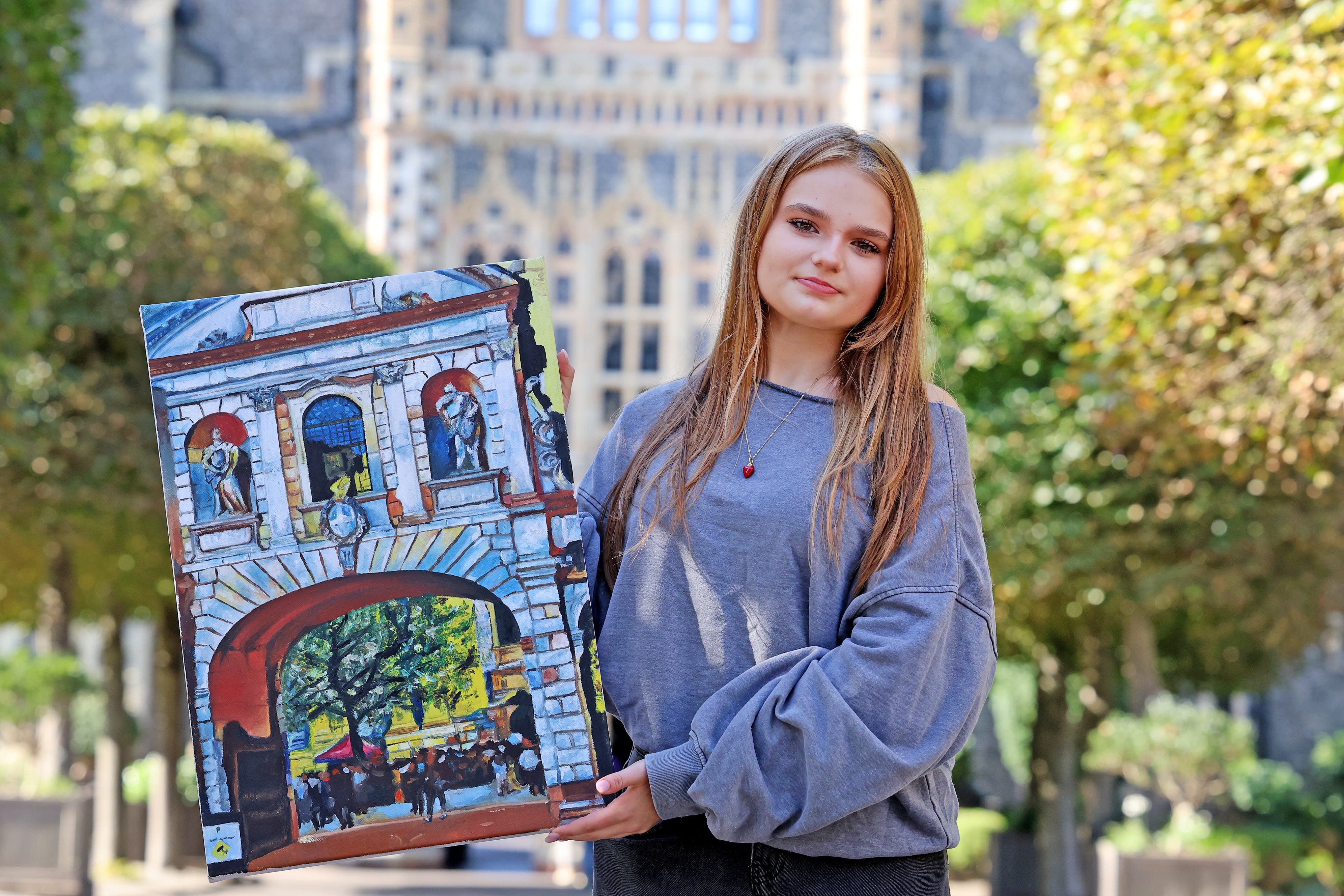 Ukrainian refugee Liza Minenko holds one of her top marked GCSE art pieces (Brighton College/PA)