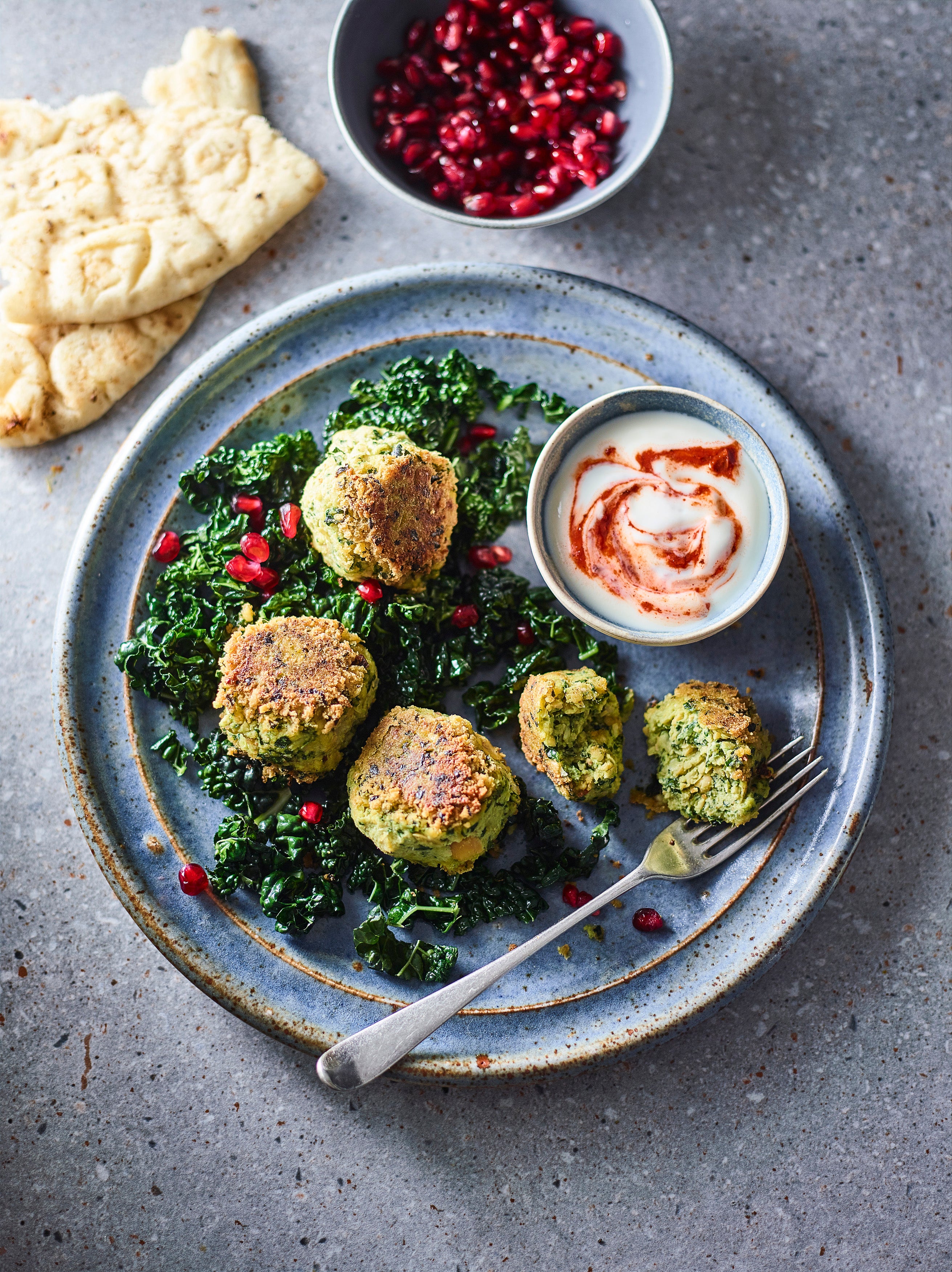 Golden, crisp falafels with a hidden veg twist, served on a bed of greens and spicy yoghurt