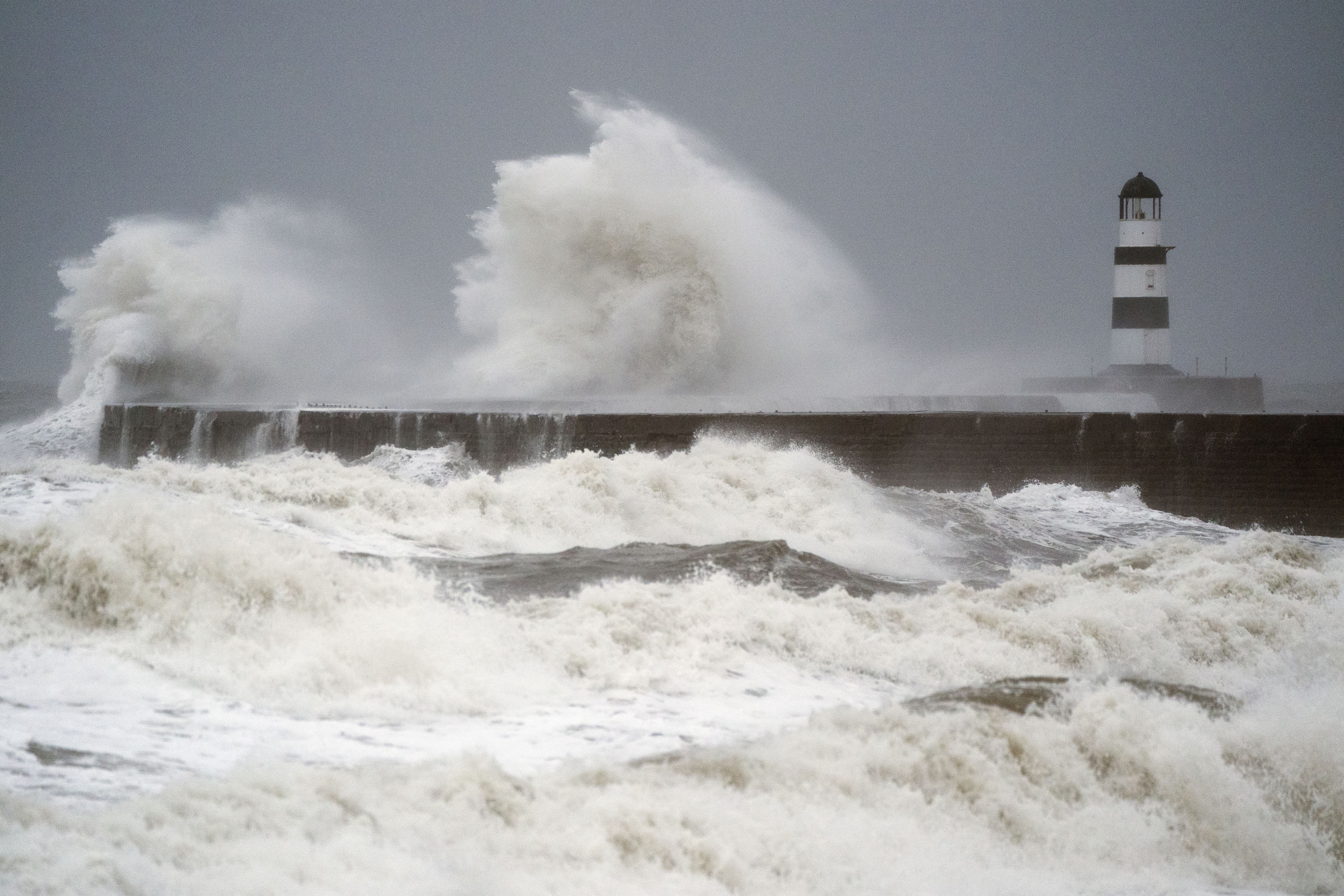 Waves crash against the lighthouse in Seaham Harbour, County Durham (Owen Humphreys/PA)