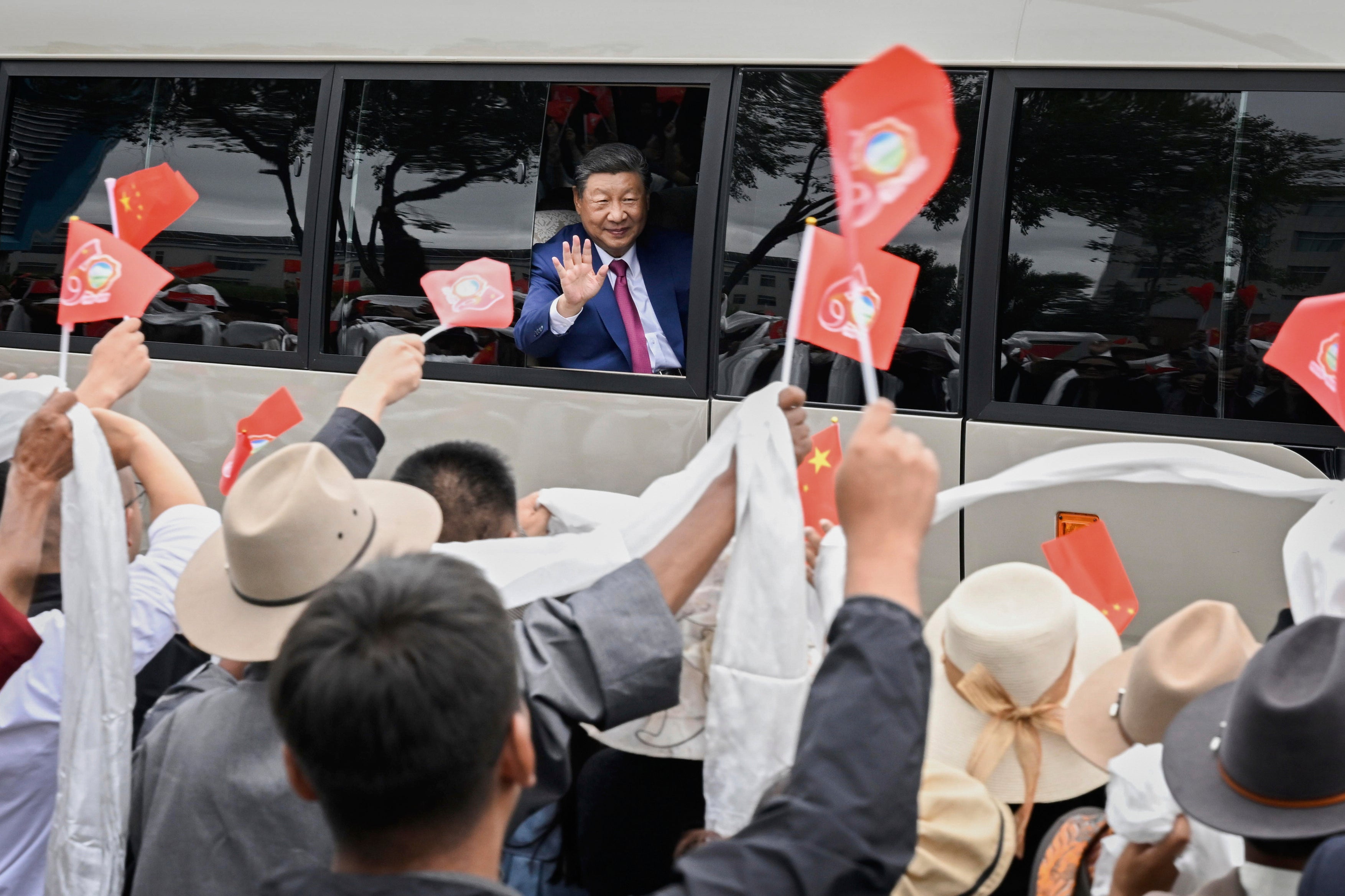 In this photo released by Xinhua News Agency, Chinese President Xi Jinping waves to people from a vehicle as he arrives at Lhasa in western China’s Tibet Autonomous Region on Wednesday, 20 August 2025, to attend an event to mark the 60th anniversary of the consolidation of Beijing’s long-contested rule over the Himalayan territory