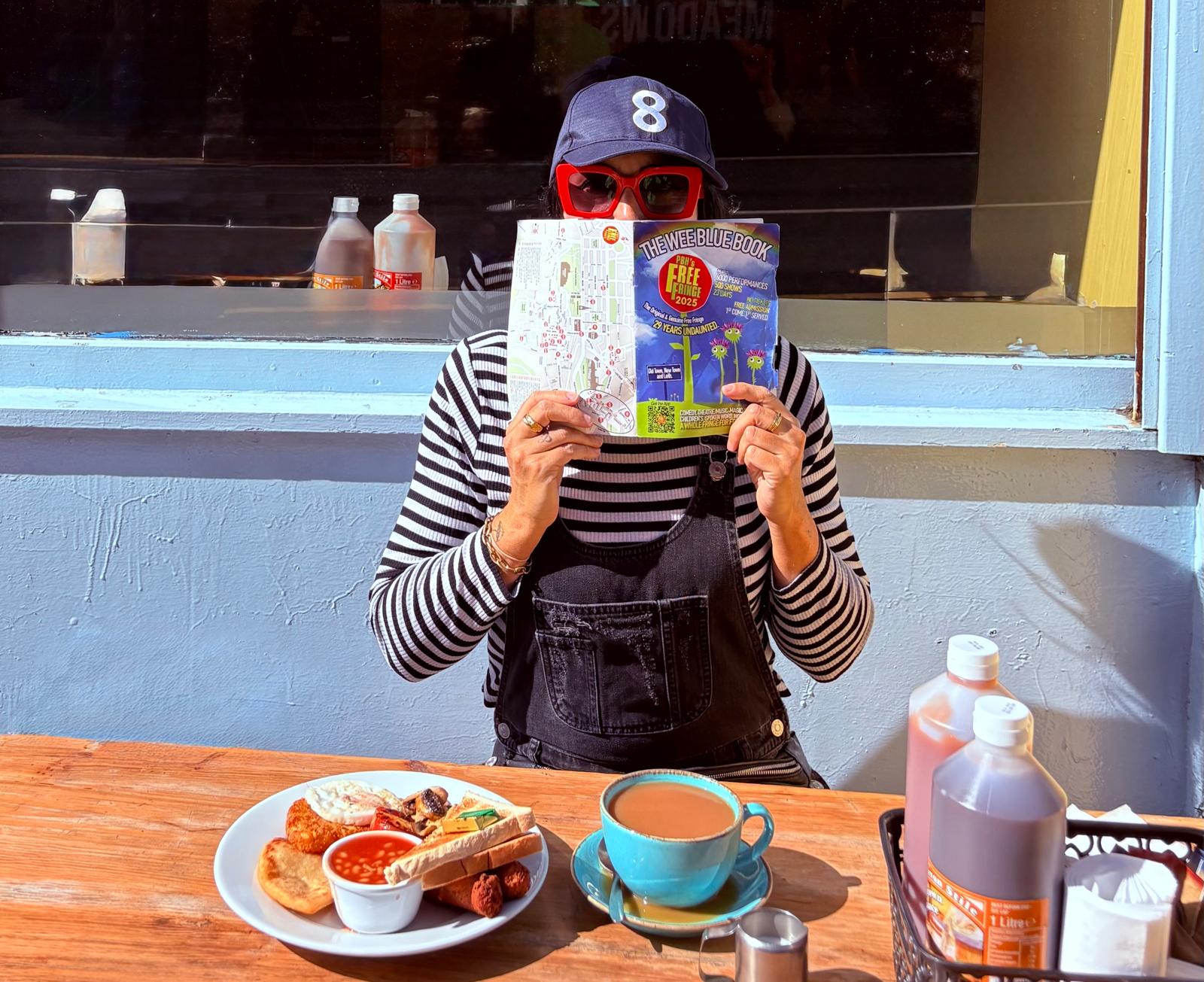 Victoria hides behind a programme guide for the Fringe