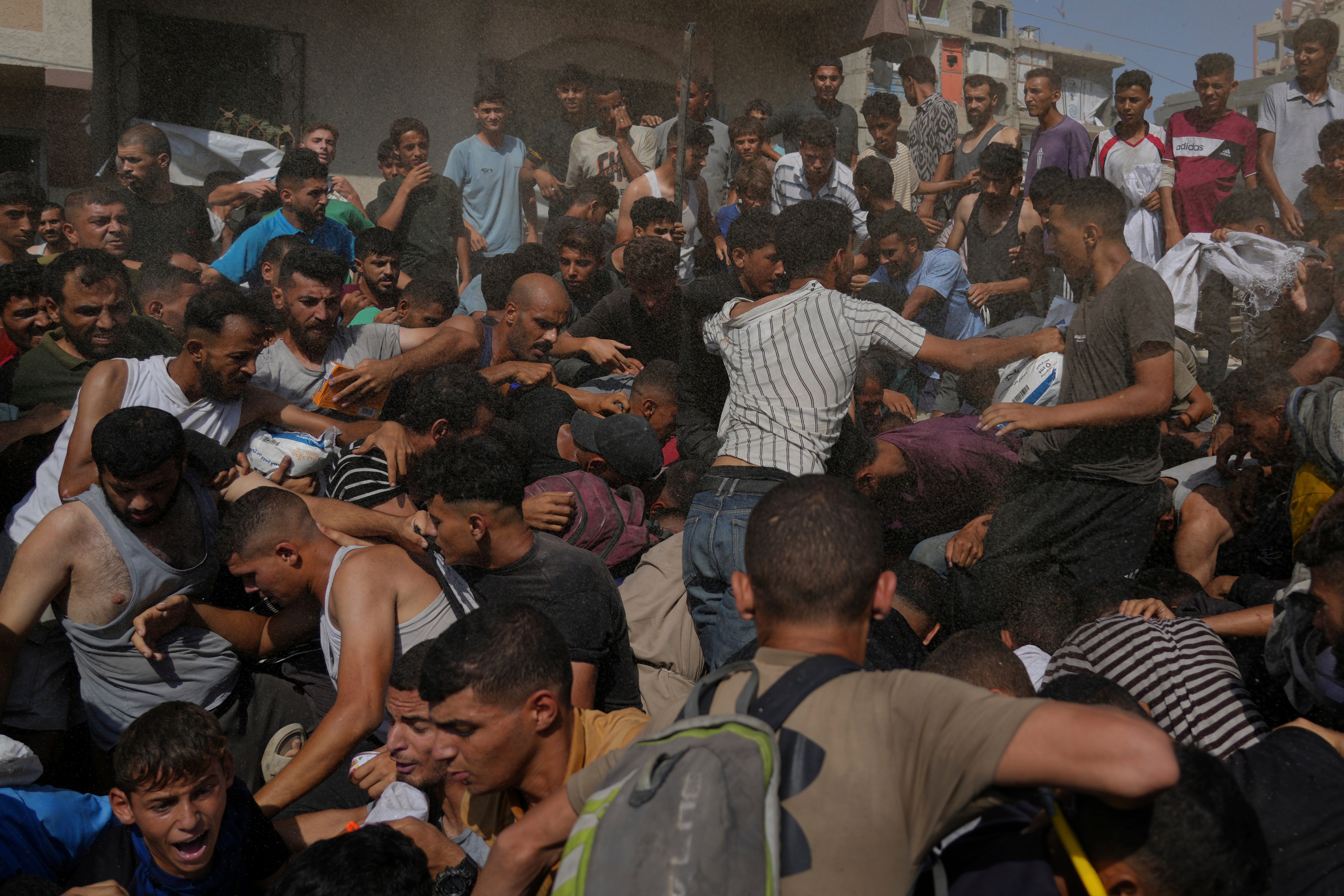 Palestinians struggle to collect humanitarian aid airdropped into Gaza City, northern Gaza Strip