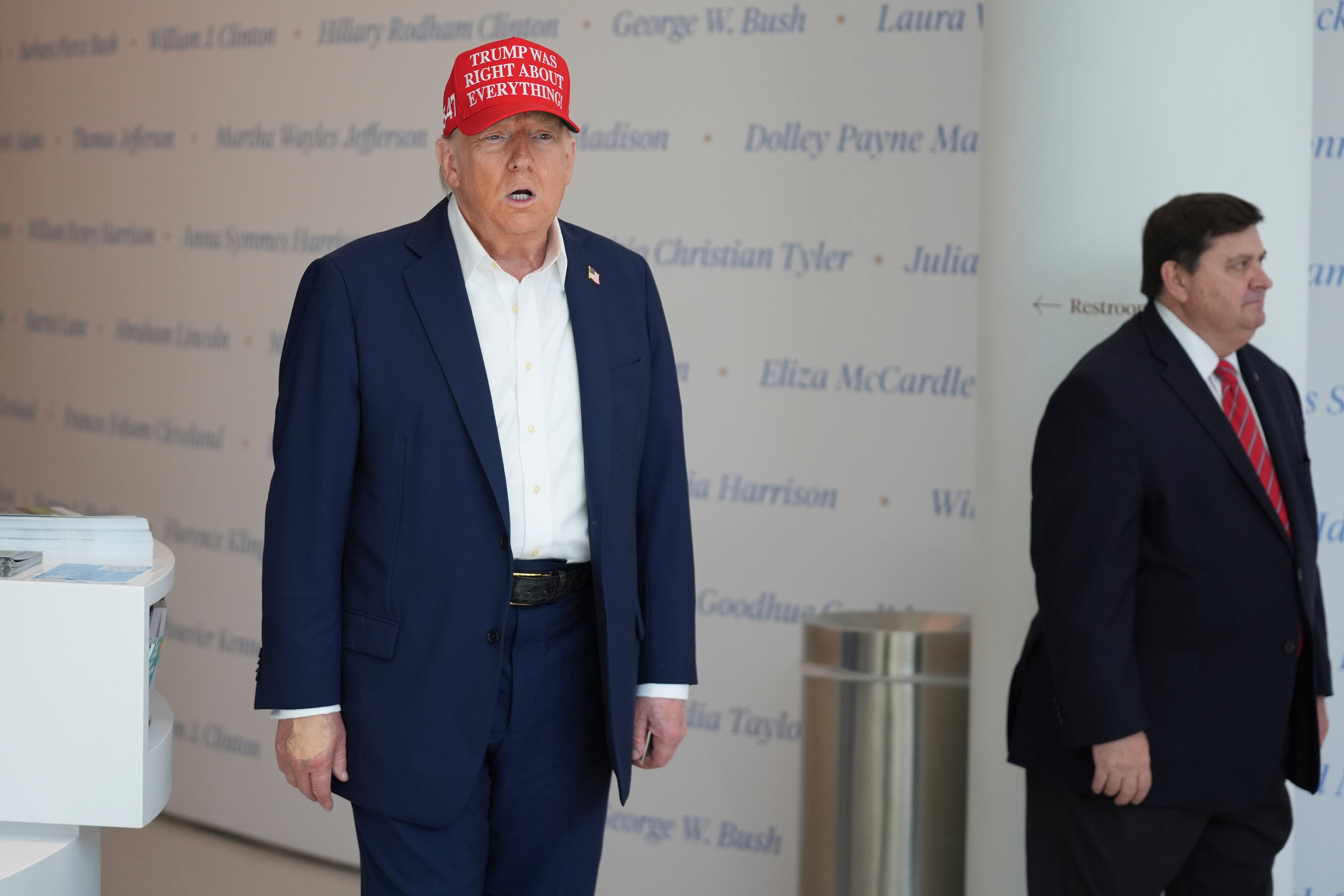 President Donald Trump speaks at The People's House museum on Friday in Washington DC, where heavy makeup was visible on his hand