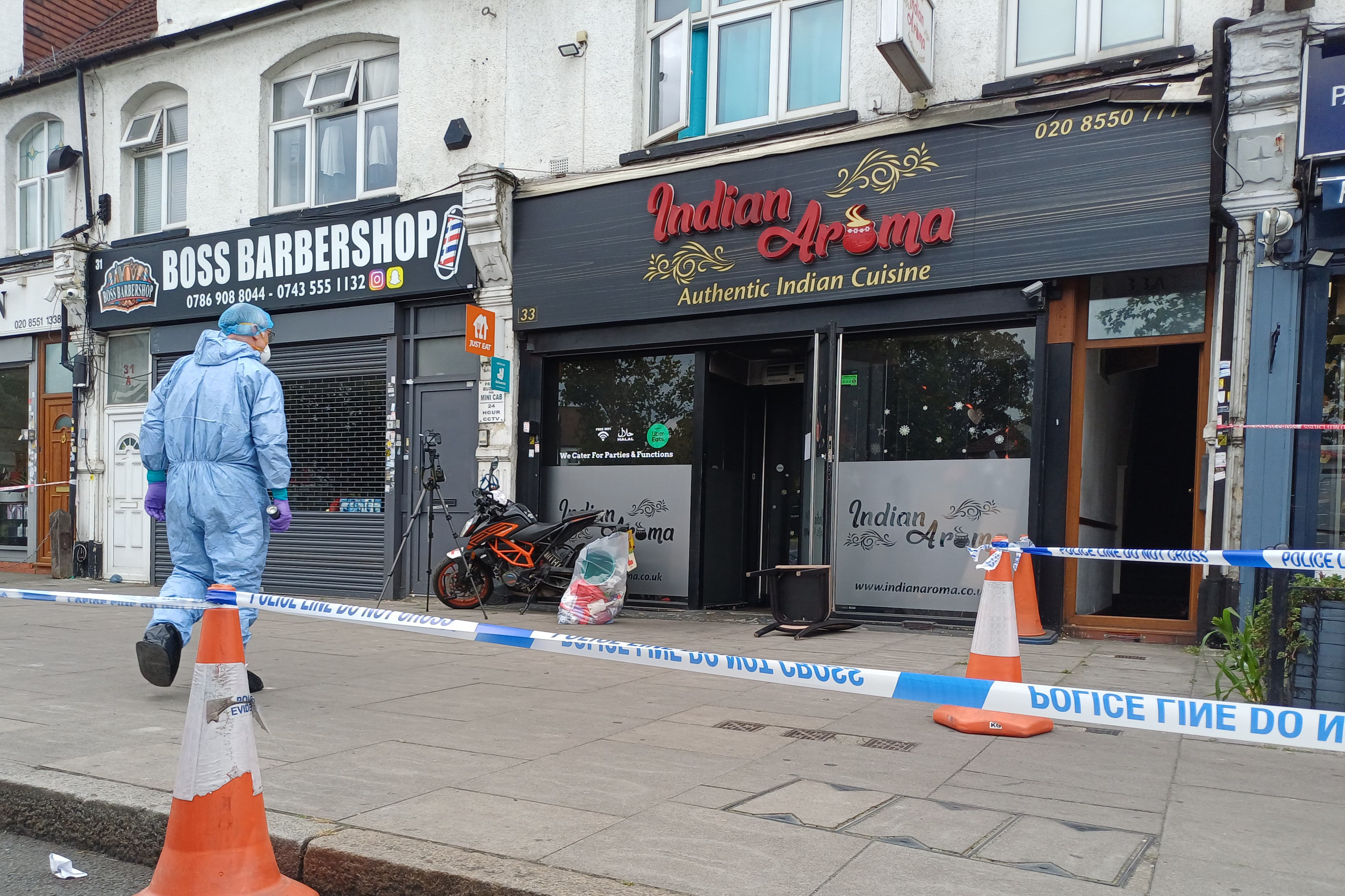 A forensic investigator at the restaurant in Ilford (Helen William/PA)