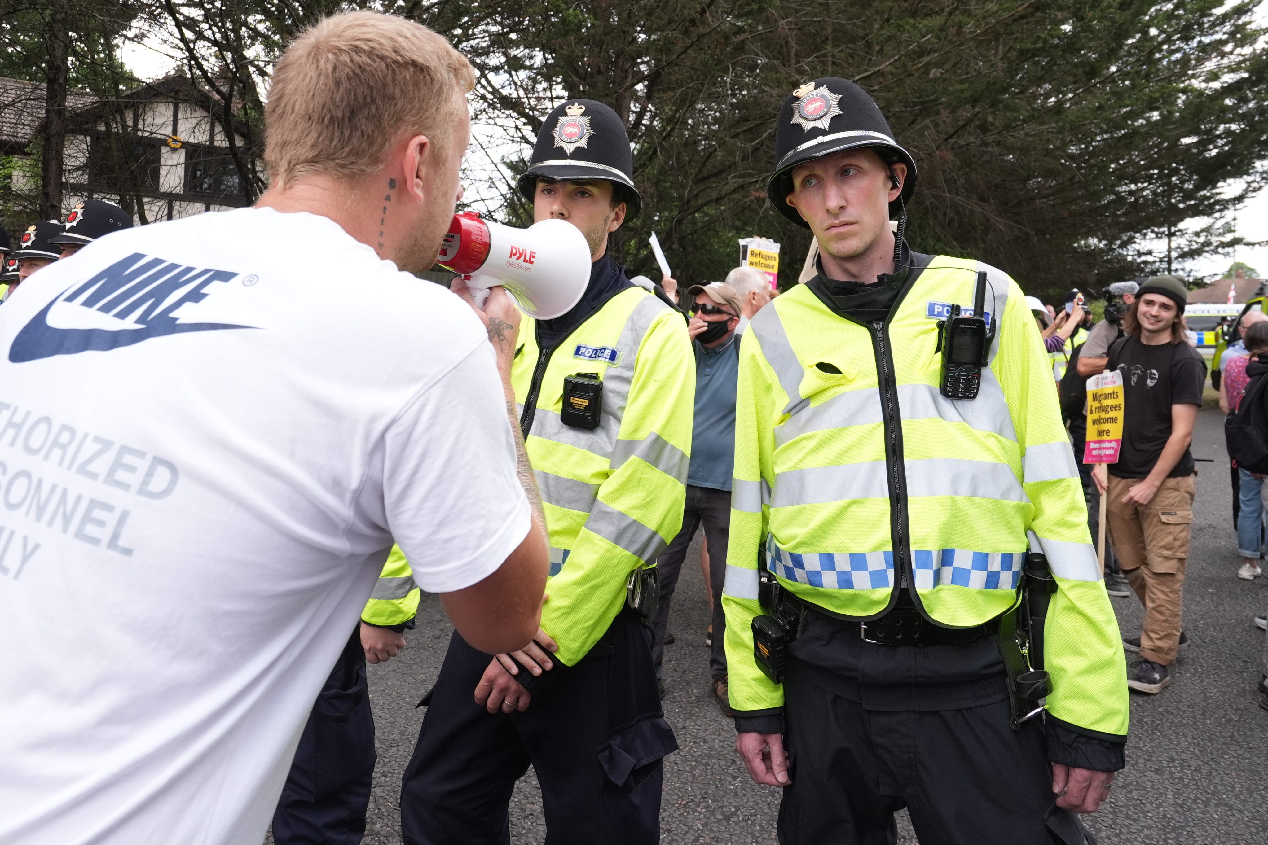 People take part in a counter protest to a Stand Up To Racism rally outside the Sheraton Four Points Hotel in Horley, Surrey (Gareth Fuller/PA)