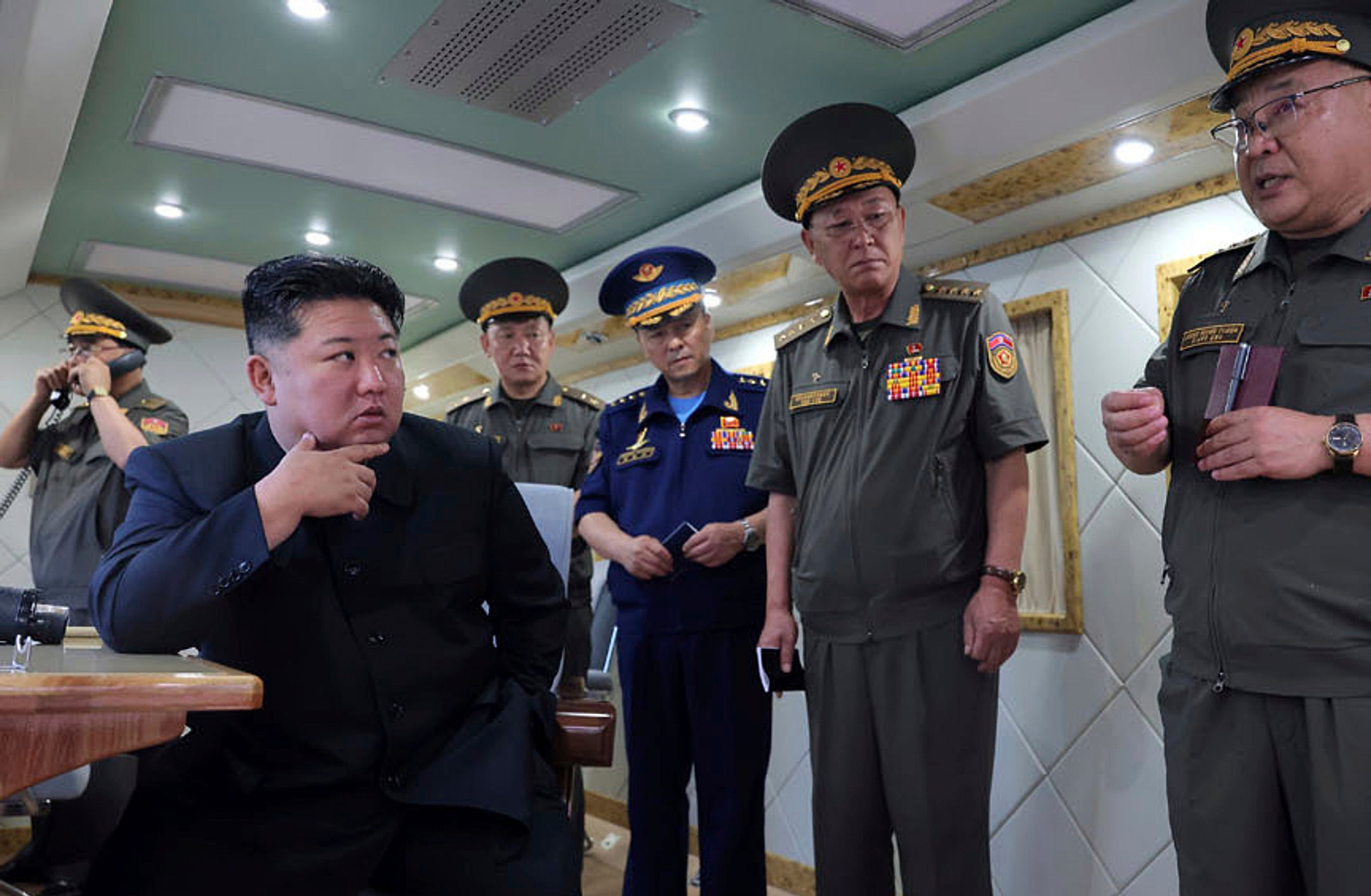 In this photo provided Sunday, 24 Aug 2025, by the North Korean government, North Korean leader Kim Jong Un, left, supervises the test-firing of two types of new anti-air missiles at undisclosed location, North Korea