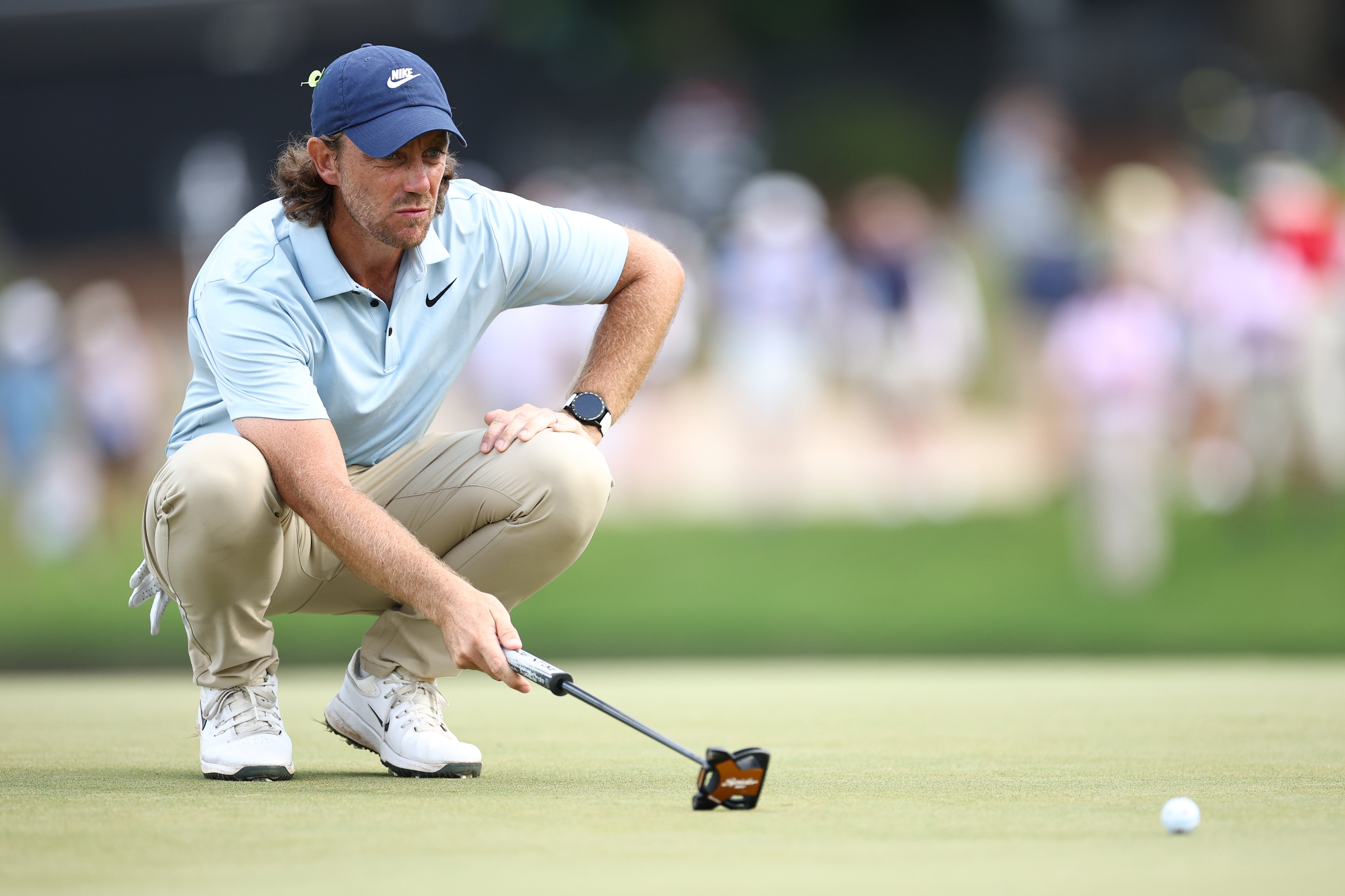 Tommy Fleetwood of England lines up a putt on the 15th green during the final round
