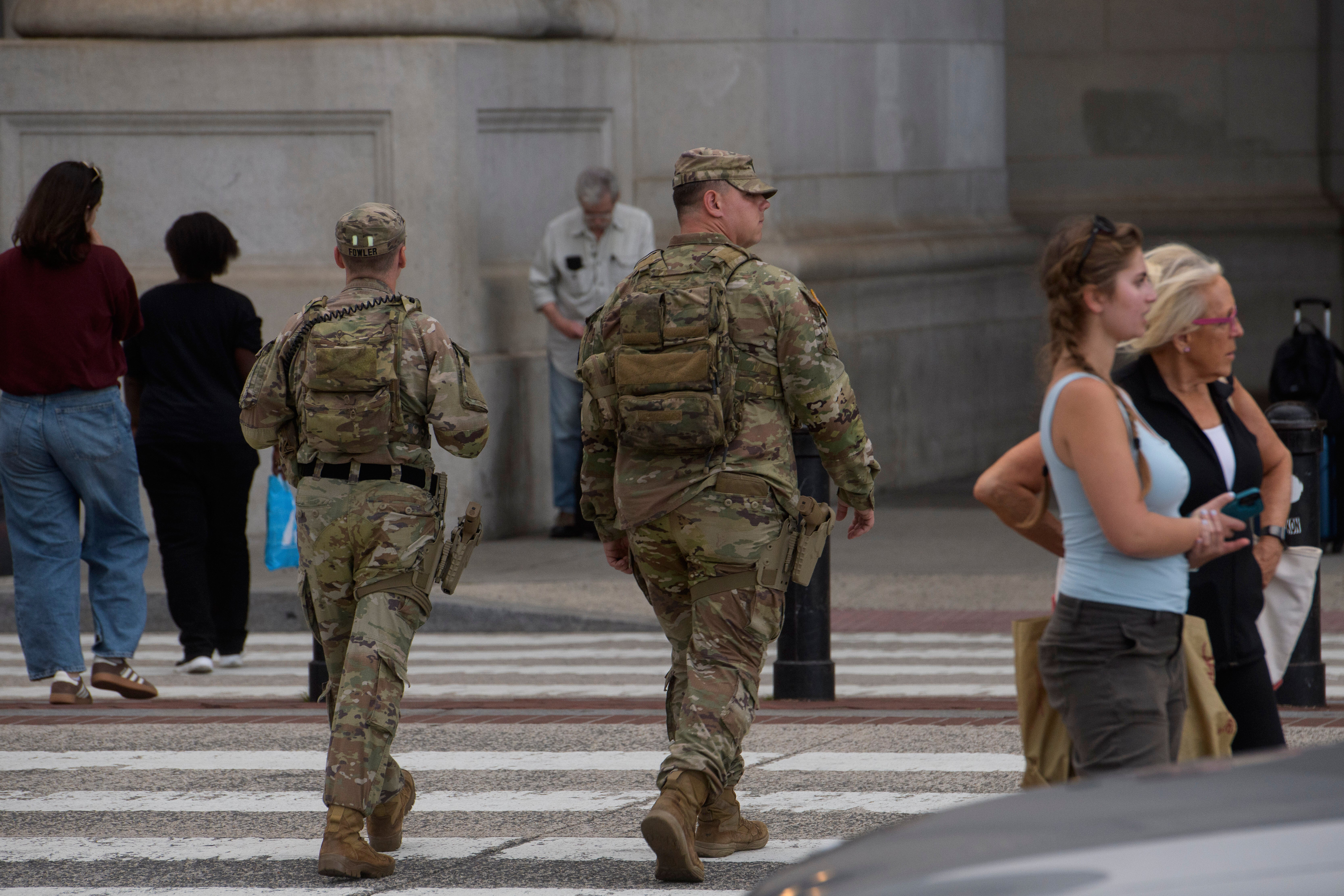 Advocacy groups warn that arming troops is a ‘dangerous escalation’ as the president brags about a drop in murders in the nation’s capital