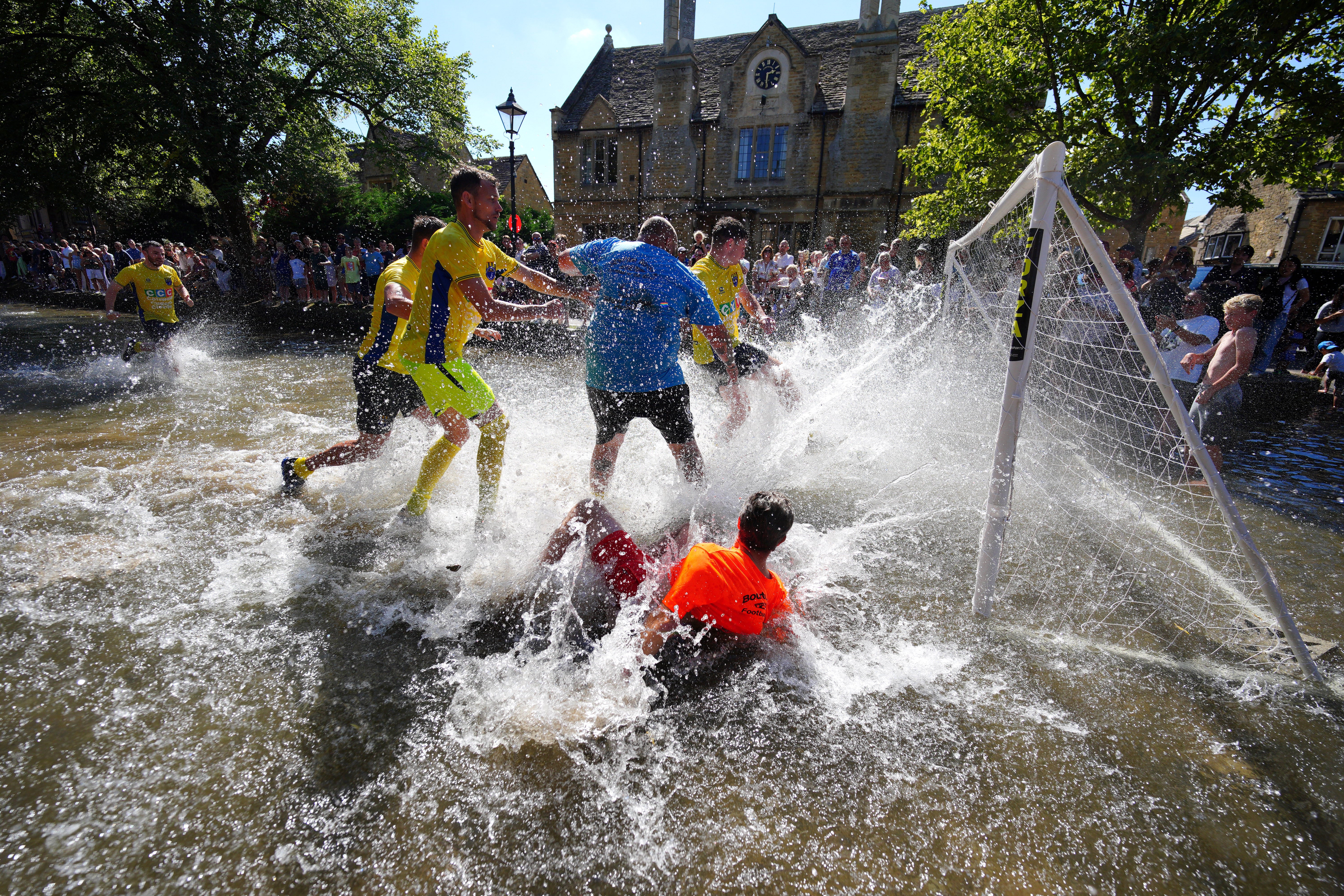 The players created a splash as they fight for the ball (Ben Birchall/PA)
