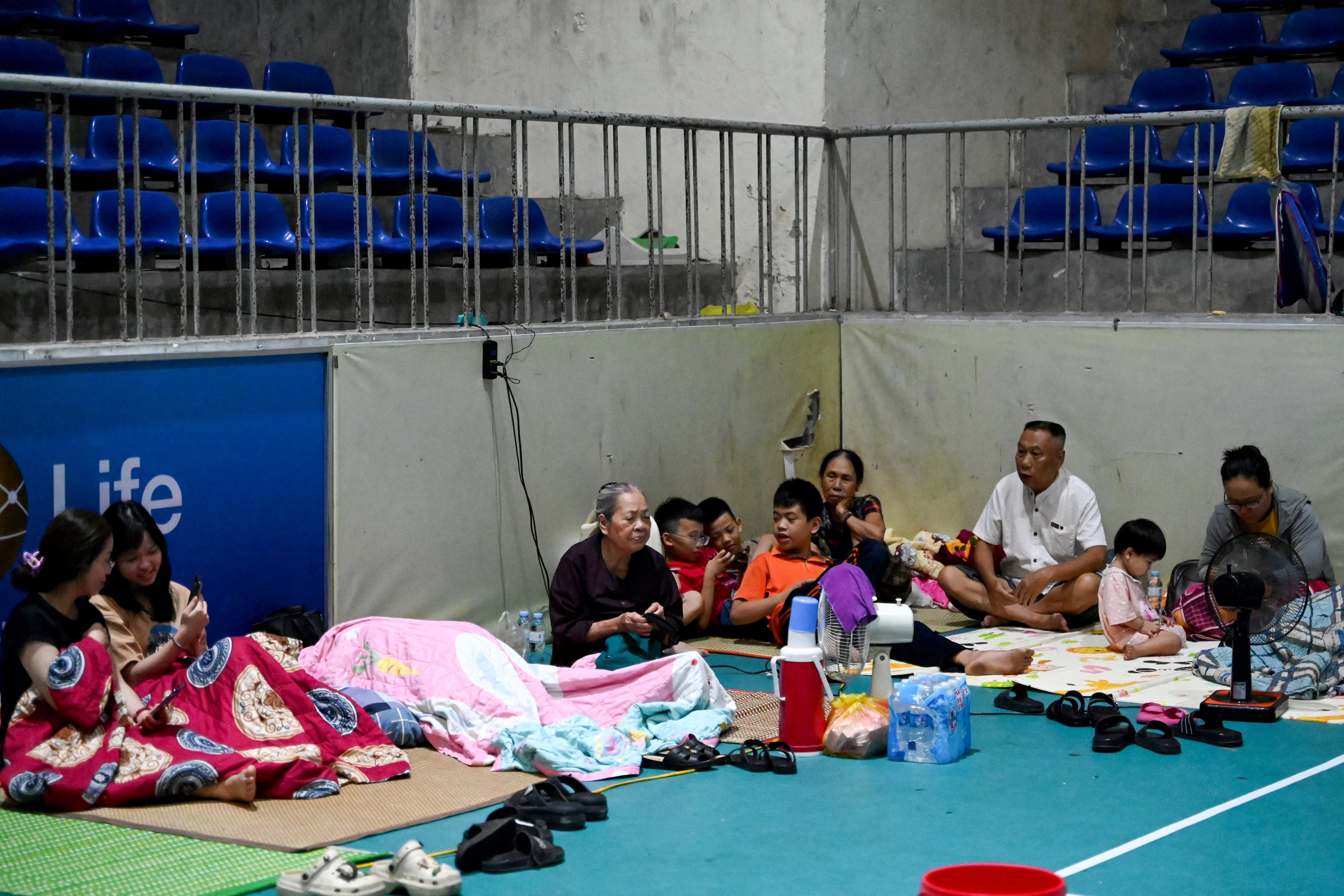 People take shelter inside the Nghe An Provincial Gymnasium in Vinh city, Nghe An province, on 25 August 2025, before Typhoon Kajiki makes landfall in Vietnam