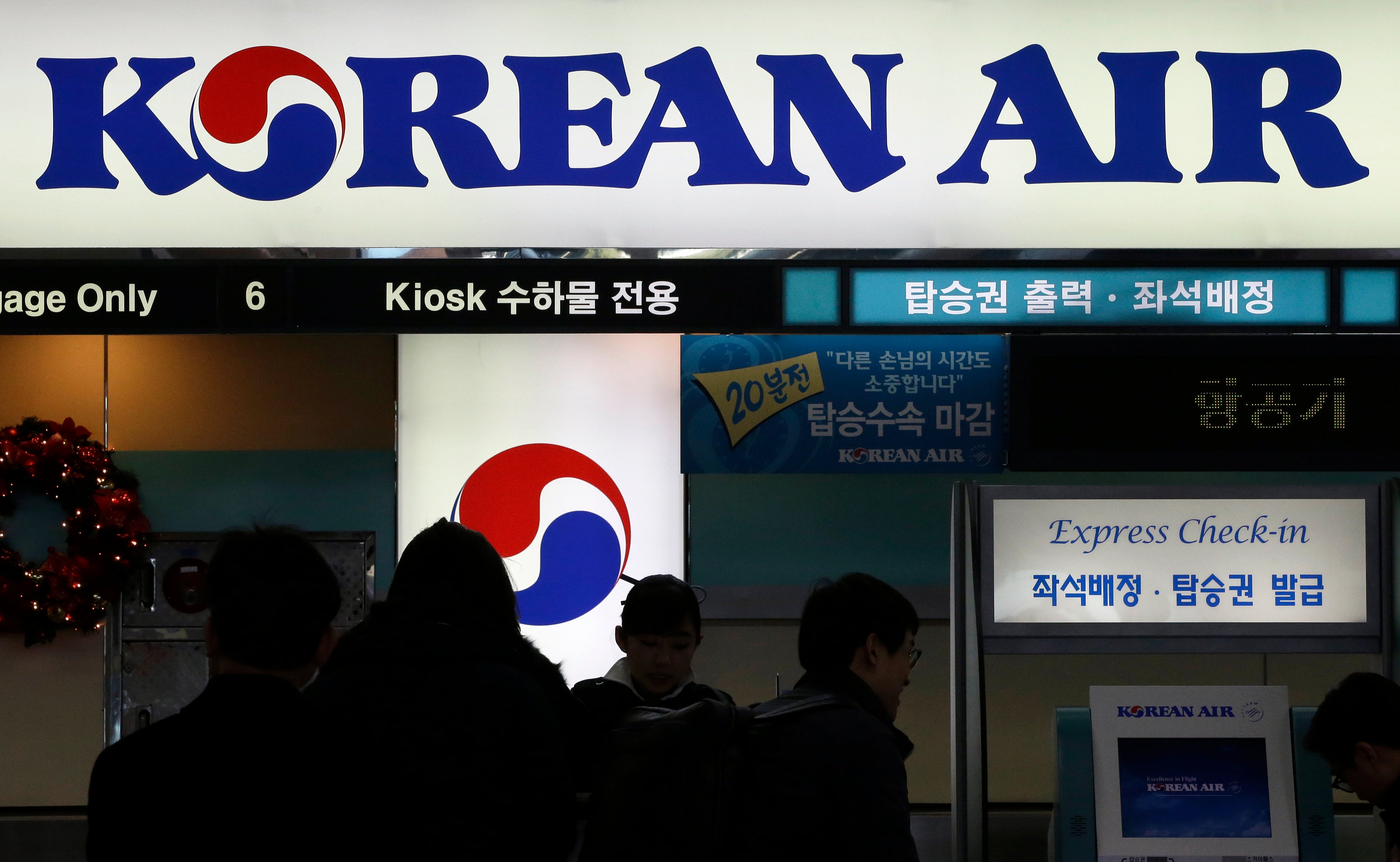 File. Passengers wait to check in at a Korean Air counter at Gimpo airport in Seoul