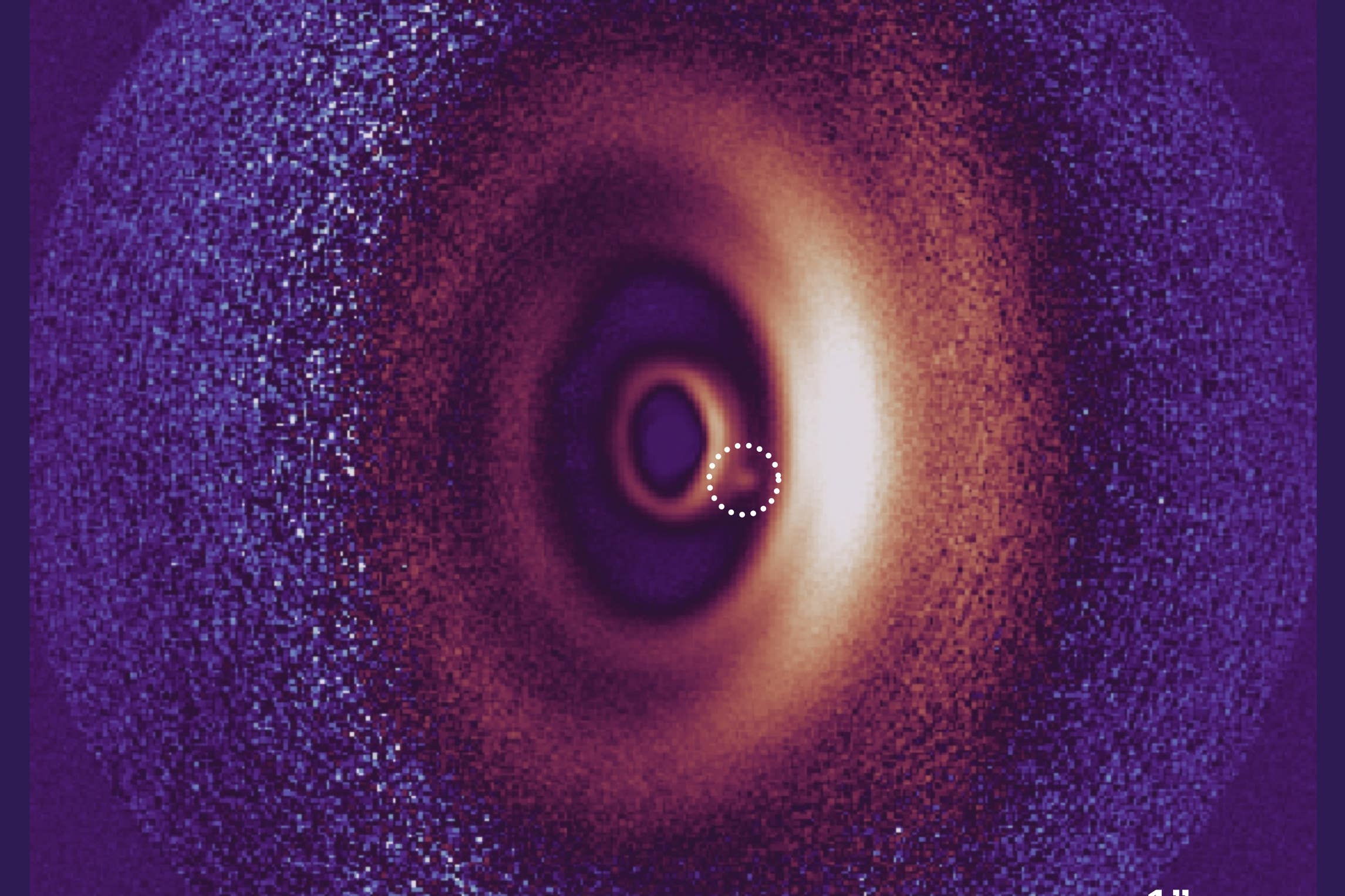 This image shows a dusty disk around a young star, including a small dot of light, which is an image of a newborn planet