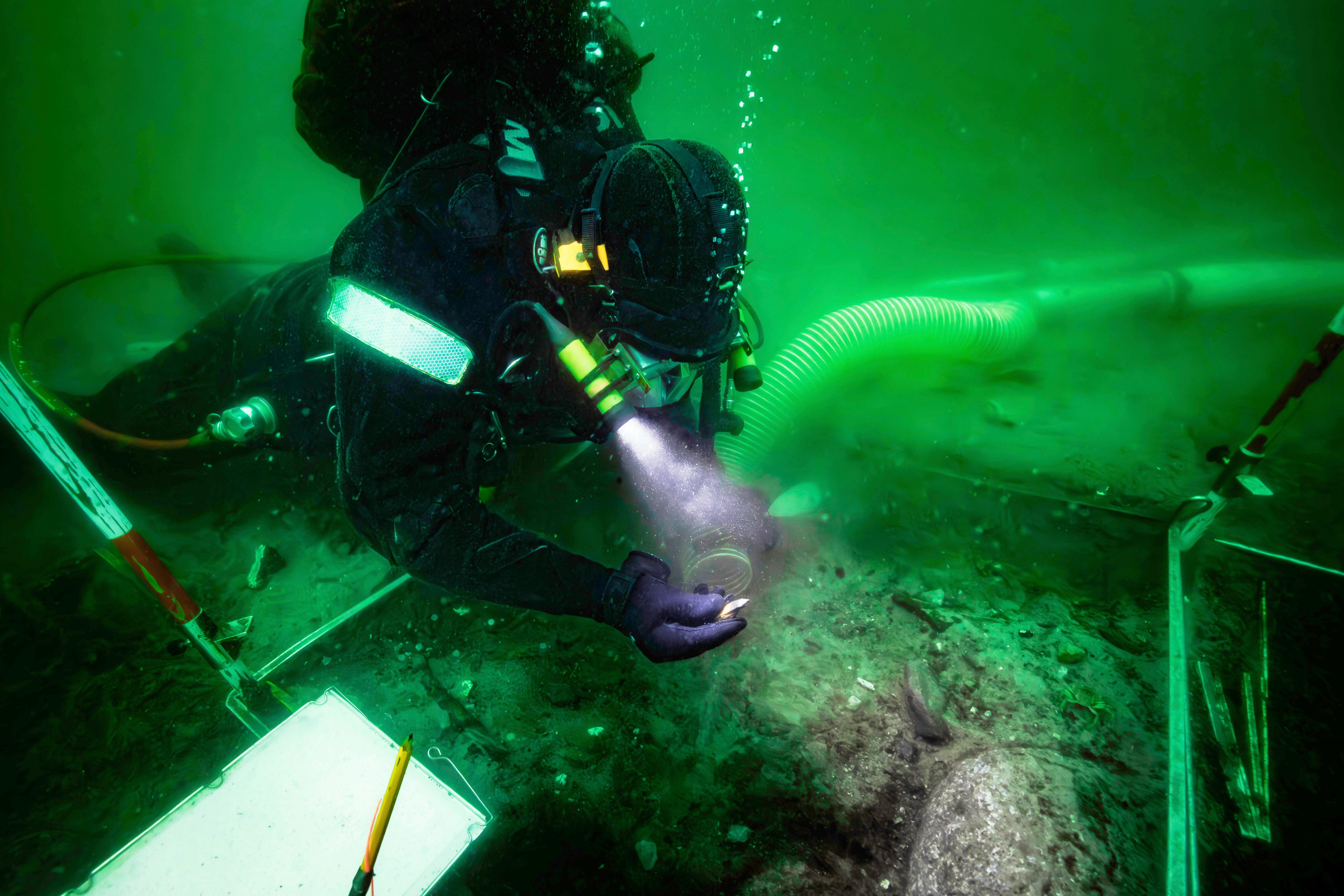A diver excavates an 8,500-year-old Stone Age coastal settlement, submerged by sea level rise in the Bay of Aarhus