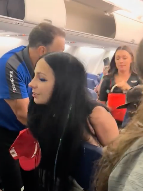 Leanna Perry was drunk when she boarded the plane, according to court filings, and only stopped her wild harangue after she was physically restrained