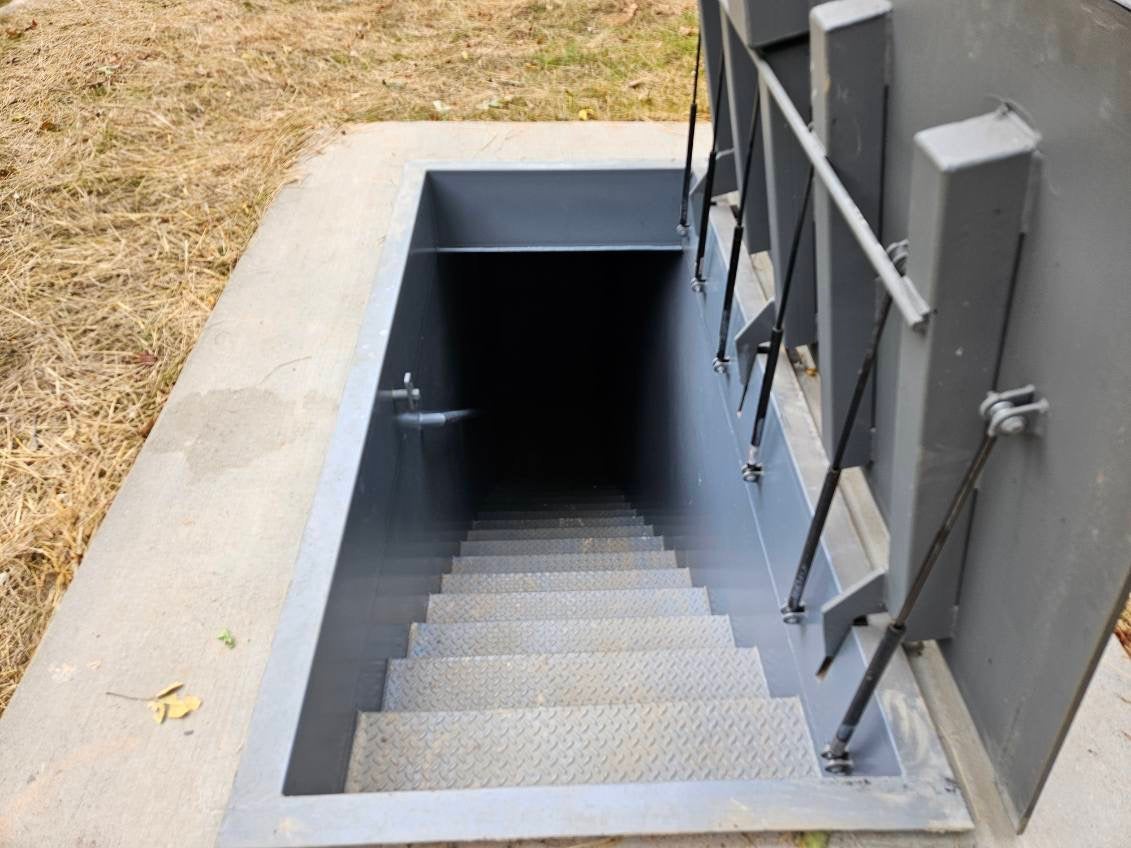 The subterranean bunkers made by Atlas Survival Shelters are incorporated into existing homes, with escape hatches that can be hidden under kitchen islands or other furniture. The hatch then opens to reveal a set of steps that leads down into the bunker