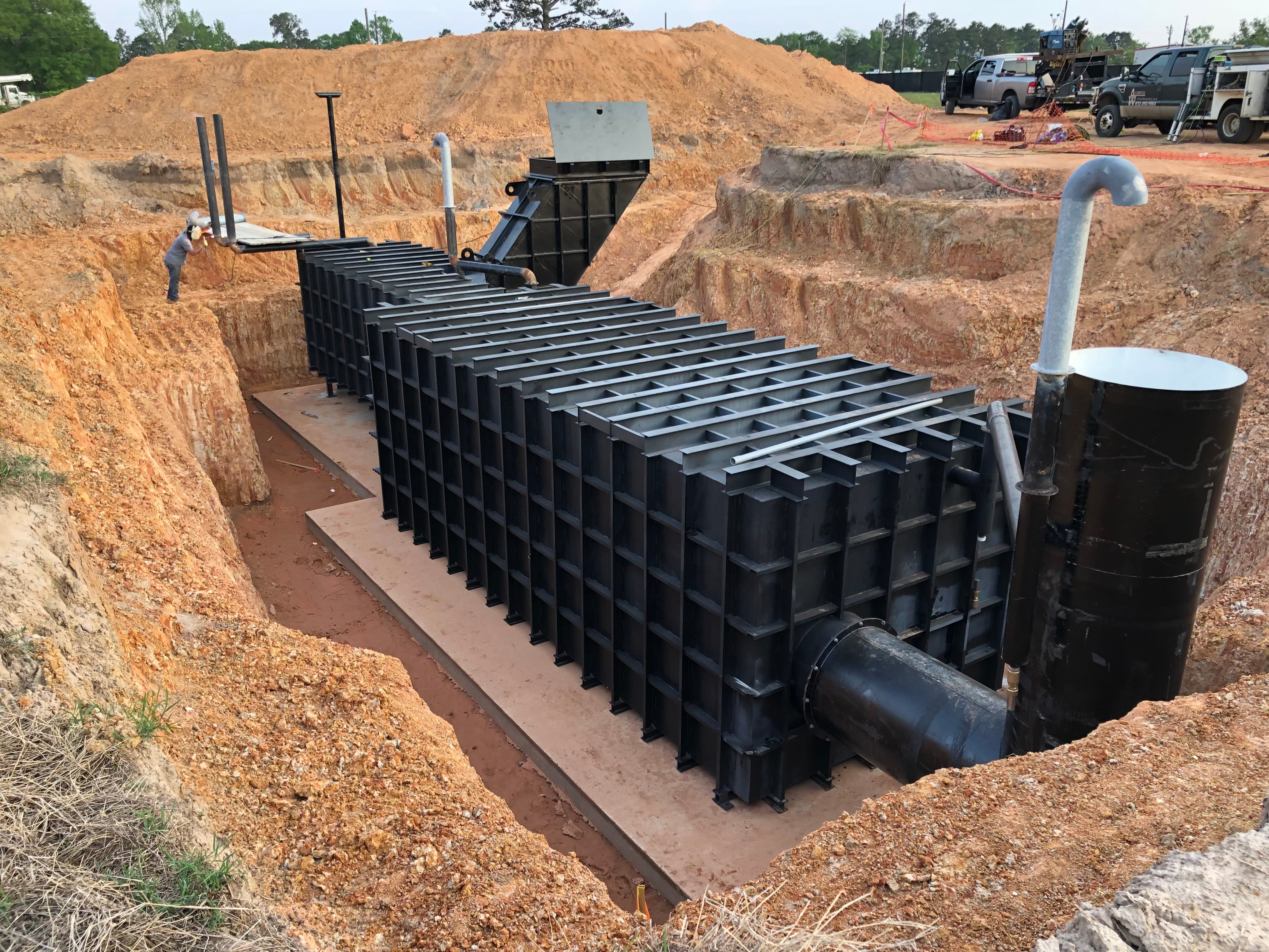 Another angle on the in-ground bunker before concreting, with the air filtration pipe sticking out at the top and the generator and air system inside the cylinders in the foreground