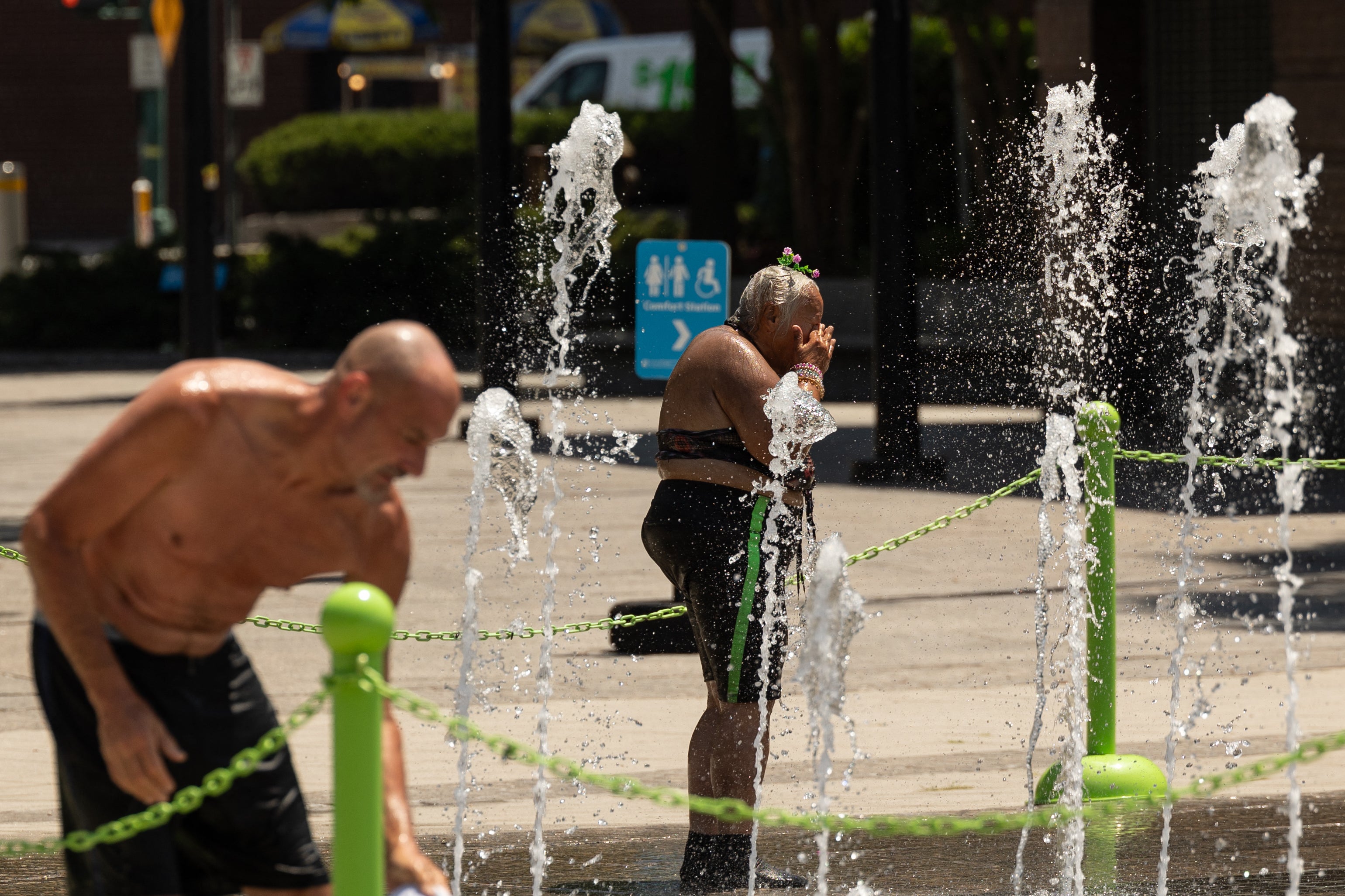 People cool off in a water fountain last summer in New York City. Last year was the hottest year on record