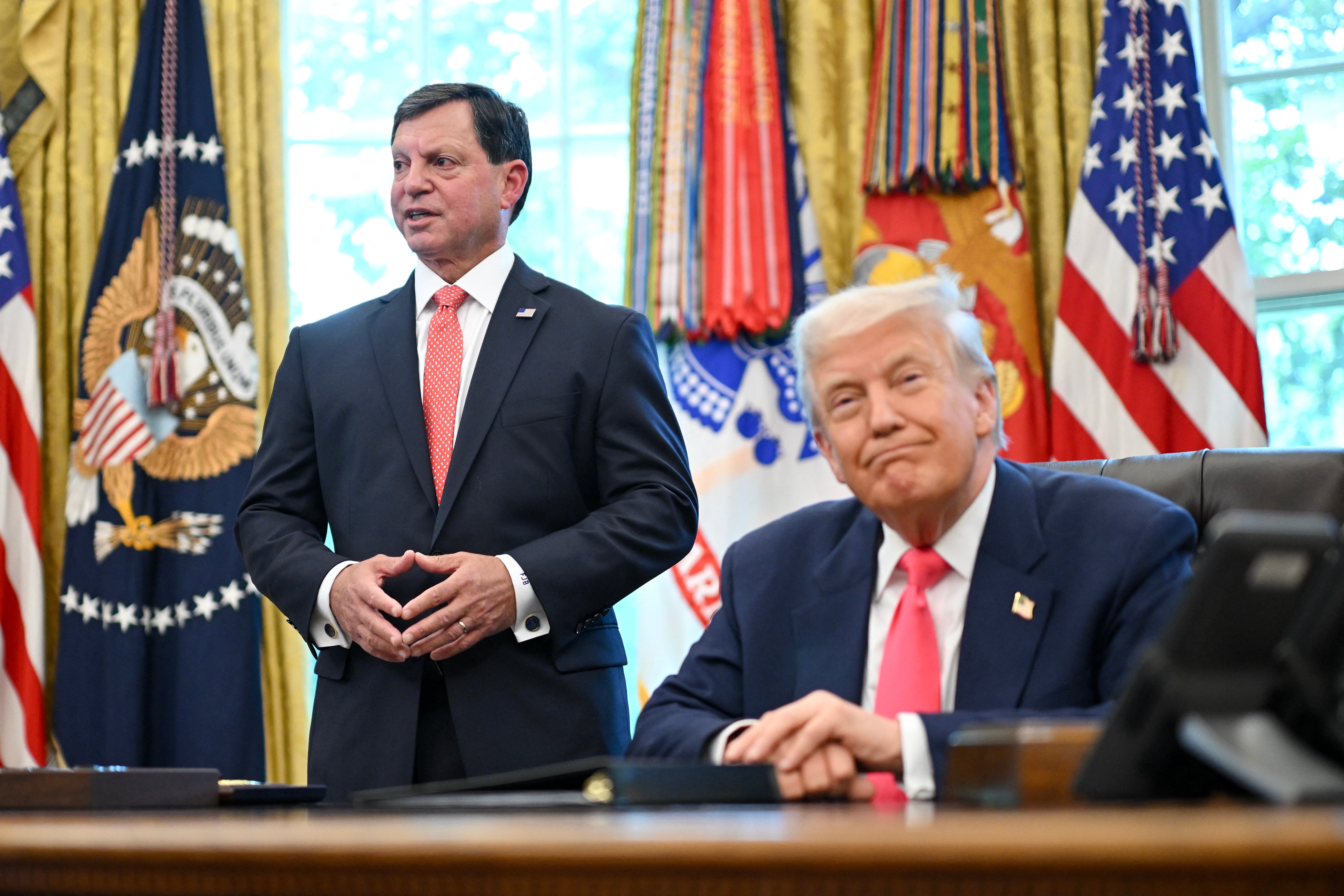 In a letter to Social Security Commissioner Frank Bisignano, pictured with President Donald Trump, Charles Borges said that he was ‘involuntarily leaving’ his role at the agency