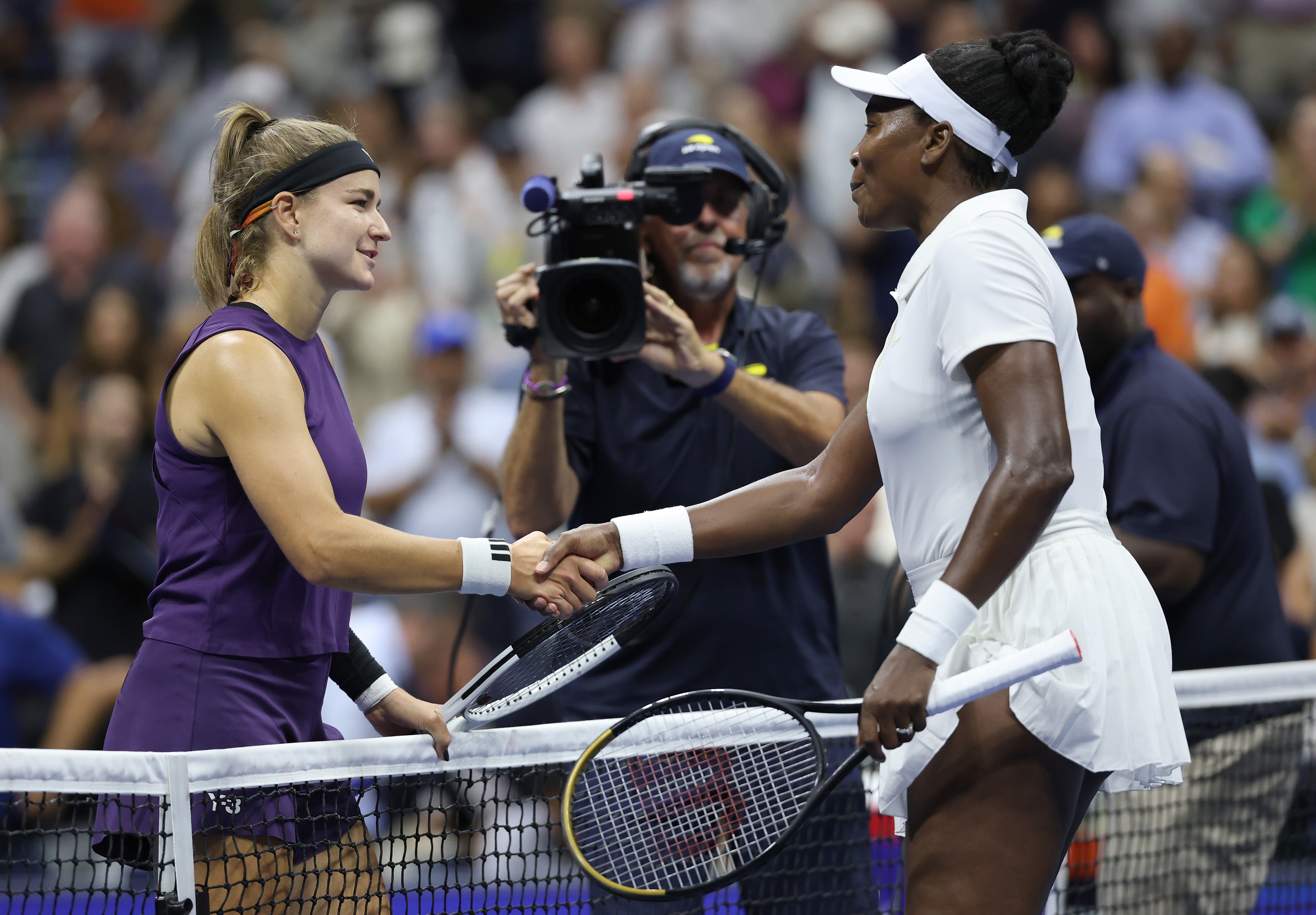 Karolina Muchova greets Venus Williams at the net after winning their first-round match